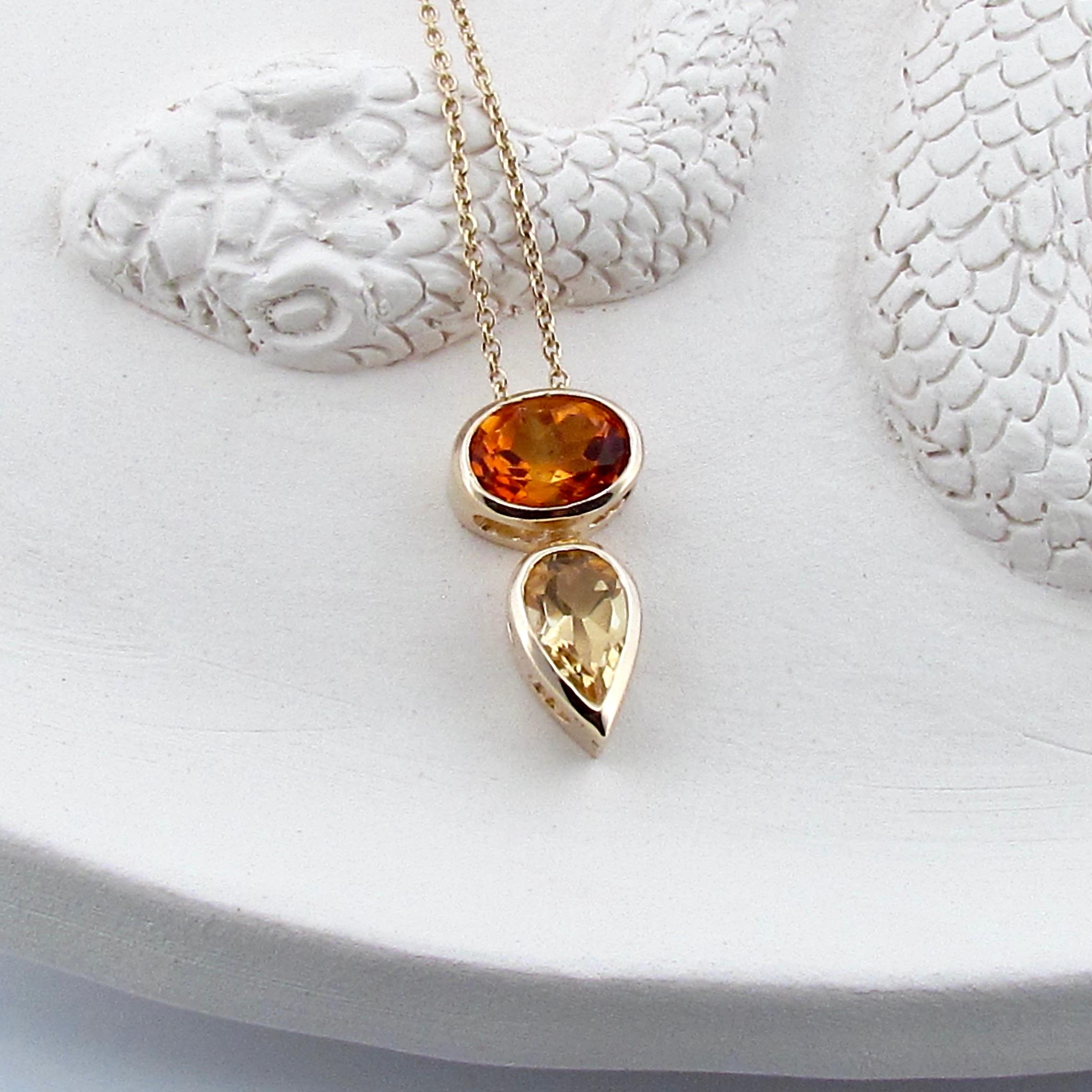 This 9ct solid Gold Balance pendant is set with a rare deep orange faceted Madeira Citrine and a pear shaped faceted bright yellow Citrine, it slides beautifully on a solid 9ct yellow gold 50cm/20inch delicate cable chain.   The dark and bright hues