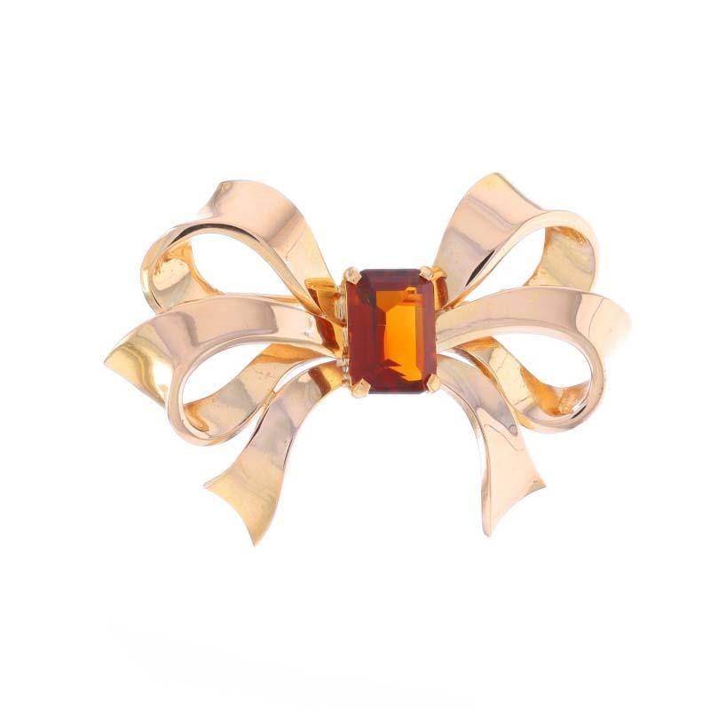 Metal Content: 18k Yellow Gold

Stone Information

Natural Citrine
Treatment: Heating
Carat(s): 2.30ct
Cut: Emerald
Color: Medeira

Total Carats: 2.30ct

Style: Brooch
Fastening Type: Hinged Pin and Trombone Clasp
Theme: Bow, Tied