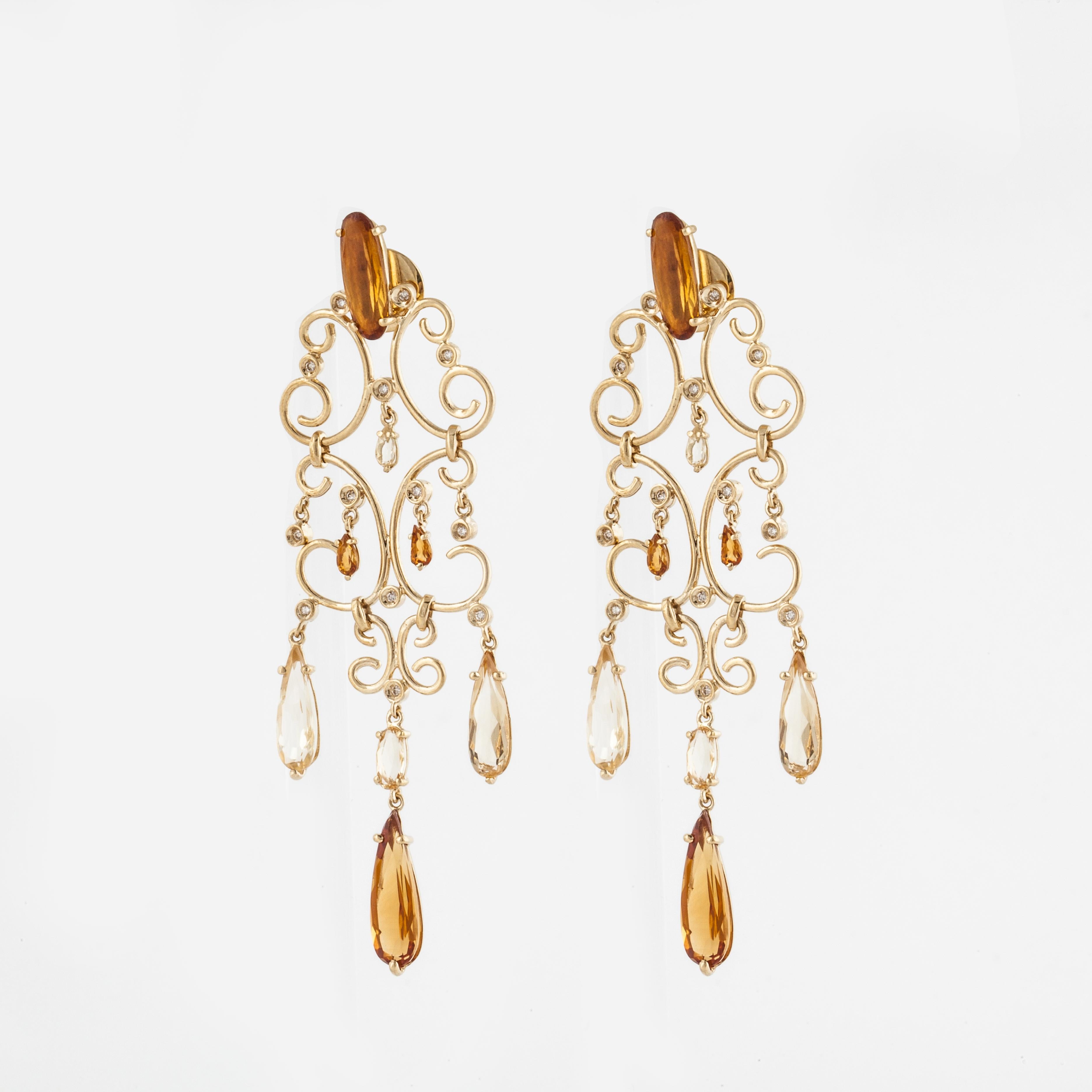 18K yellow gold dangle earrings featuring citrines.  There are 16 citrines that total 10.20 carats.  There are 26 round bezel-set diamonds that total 0.25; G-H color and VS clarity.  Measure 2 7/8 inches long and 7/8 inches wide.  