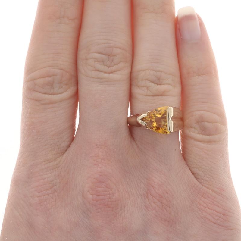 Size: 6

Metal Content: 14k Yellow Gold

Stone Information

Natural Citrine
Treatment: Heating
Carat(s): 1.50ct
Cut: Trillion
Color: Yellow

Total Carats: 1.50ct

Style: Cocktail Solitaire
Theme: Geometric
Features: Contoured & Knife-Edge