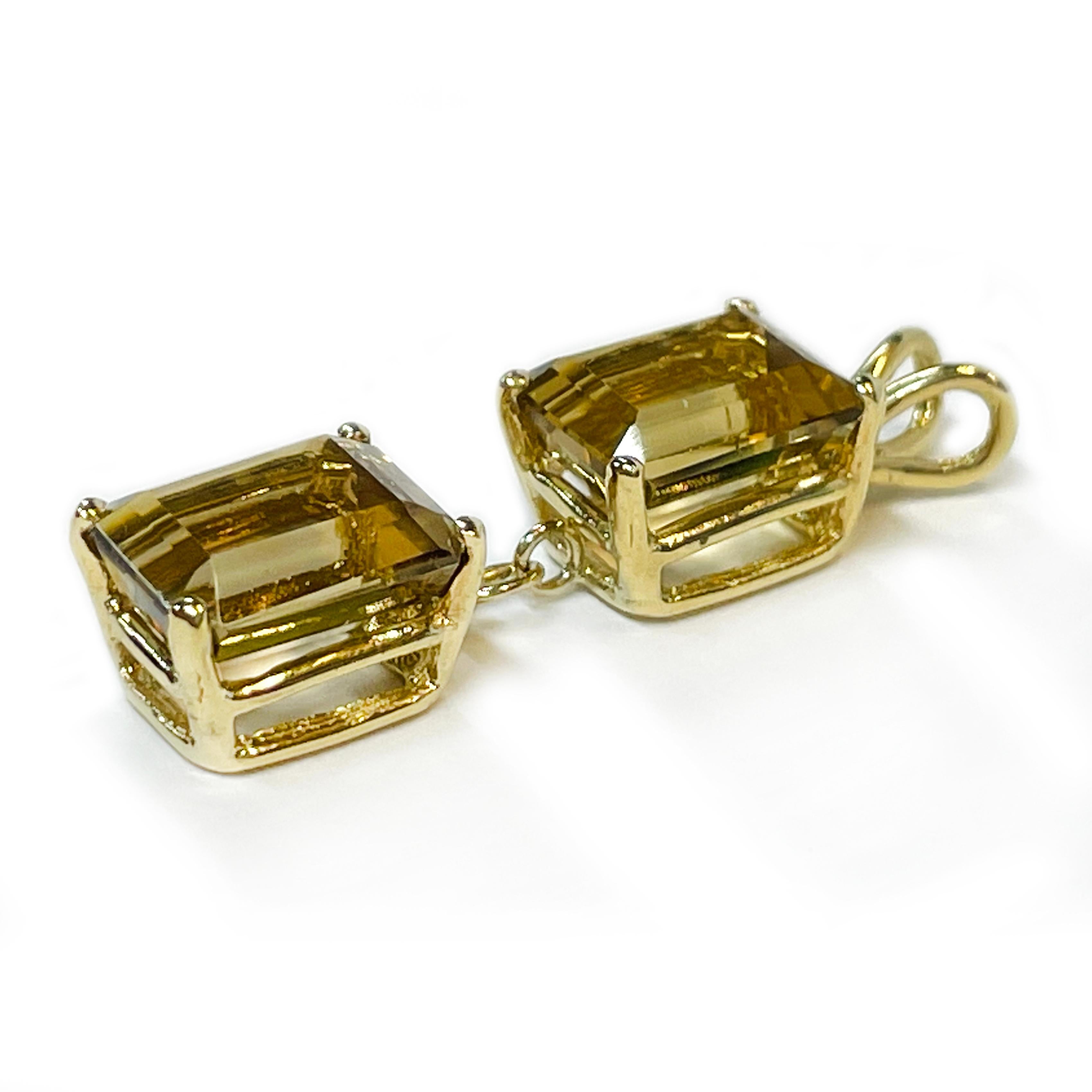 14 Karat Yellow Gold Citrine Dangle Pendant. The pendant features two 9.5 x 7.5mm Citrine emerald-cut gemstones. The light gold/brown color gemstones are four-prong set in double yellow gold base setting with a rabbit bail. The total carat weight of