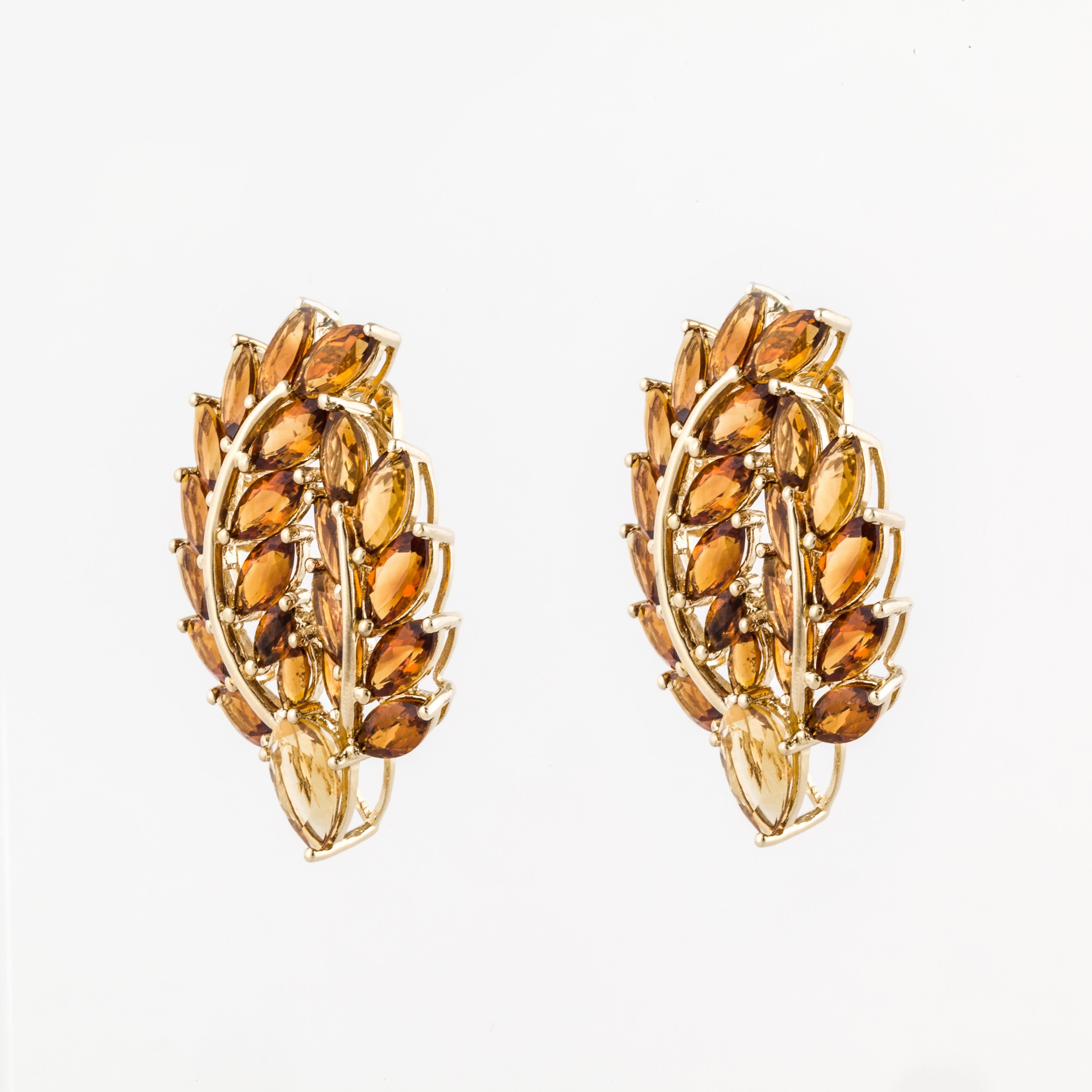 18K yellow gold cluster citrine earrings in a leaf motif.  There are forty-two marquise shaped citrines and two pear shaped citrines totaling 21 carats.  The earrings measure 1 1/2 inches long and 1 1/8 inches wide.  Clip style earrings.  