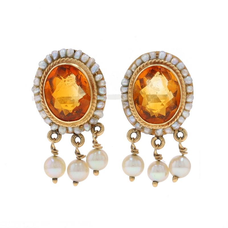 Era: Vintage

Metal Content: 14k Yellow Gold

Stone Information
Natural Citrines
Treatment: Heating
Carat(s): 7.20ctw
Cut: Oval
Color: Orange

Natural Seed Pearls

Total Carats: 7.20ctw

Style: Dangle
Fastening Type: Butterfly