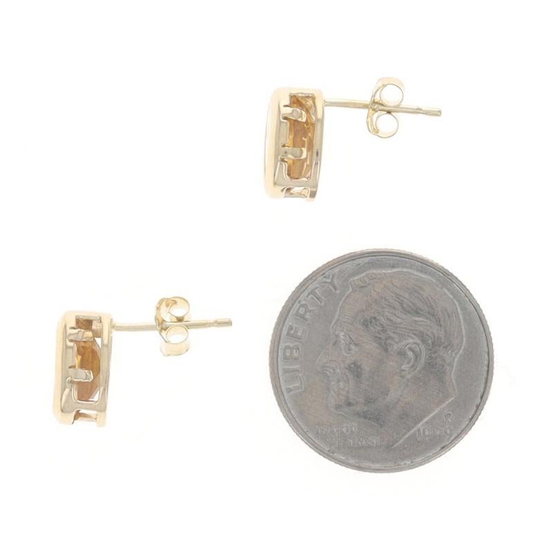 Metal Content: 14k Yellow Gold

Stone Information

Natural Citrine
Treatment: Heating
Carat(s): 1.70ctw
Cut: Oval

Total Carats: 1.70ctw

Style: Stud
Fastening Type: Butterfly Closures
Features: Bezel Set

Measurements

Tall: 3/8