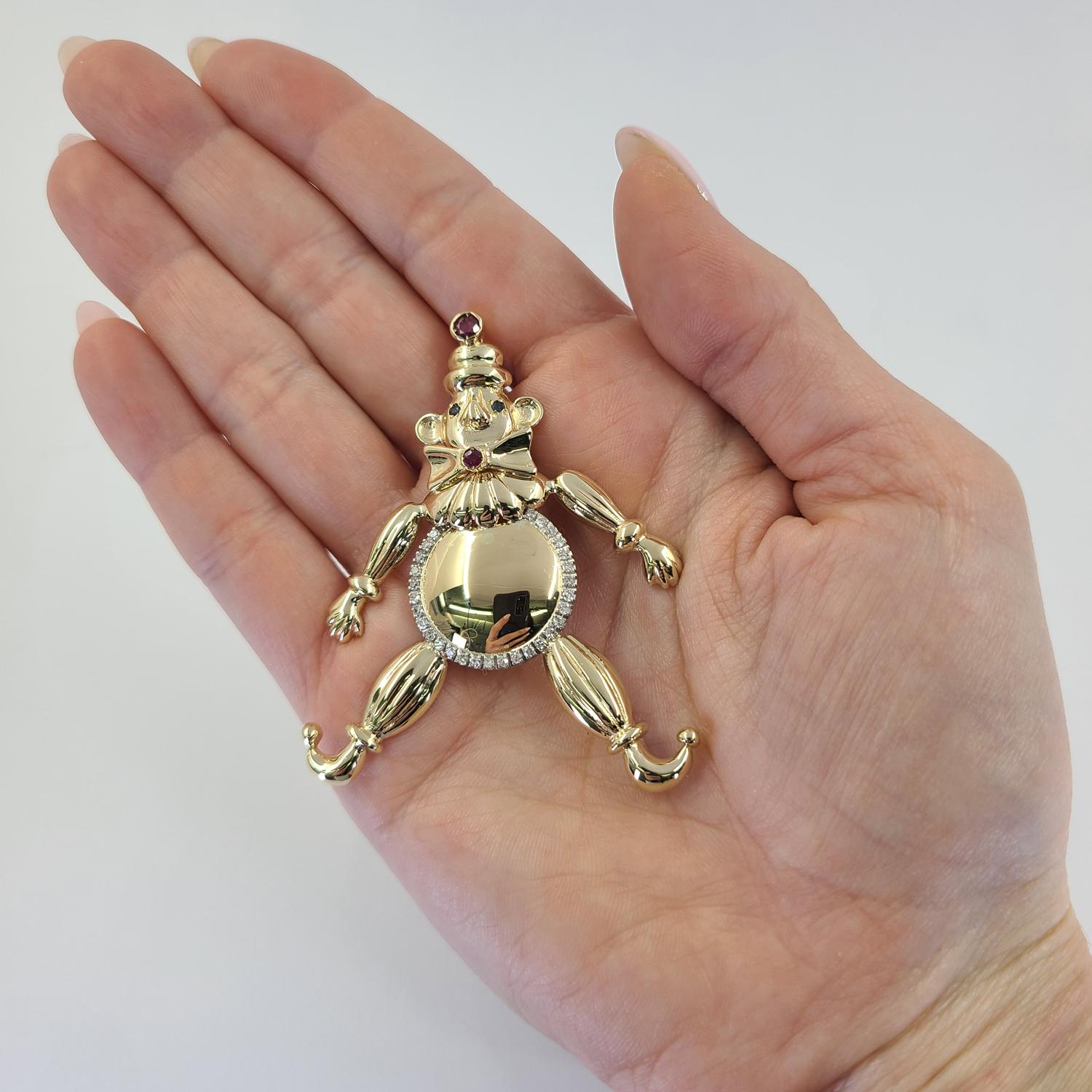18 Karat Yellow Gold Engravable Clown Pendant Featuring 29 Single Cut Diamonds of SI Clarity and G/H Color Totaling 0.22 Carats, 2 Sapphires, and 2 Rubies. 2.5 Inches Long. Finished Weight Is 12.6 Grams.