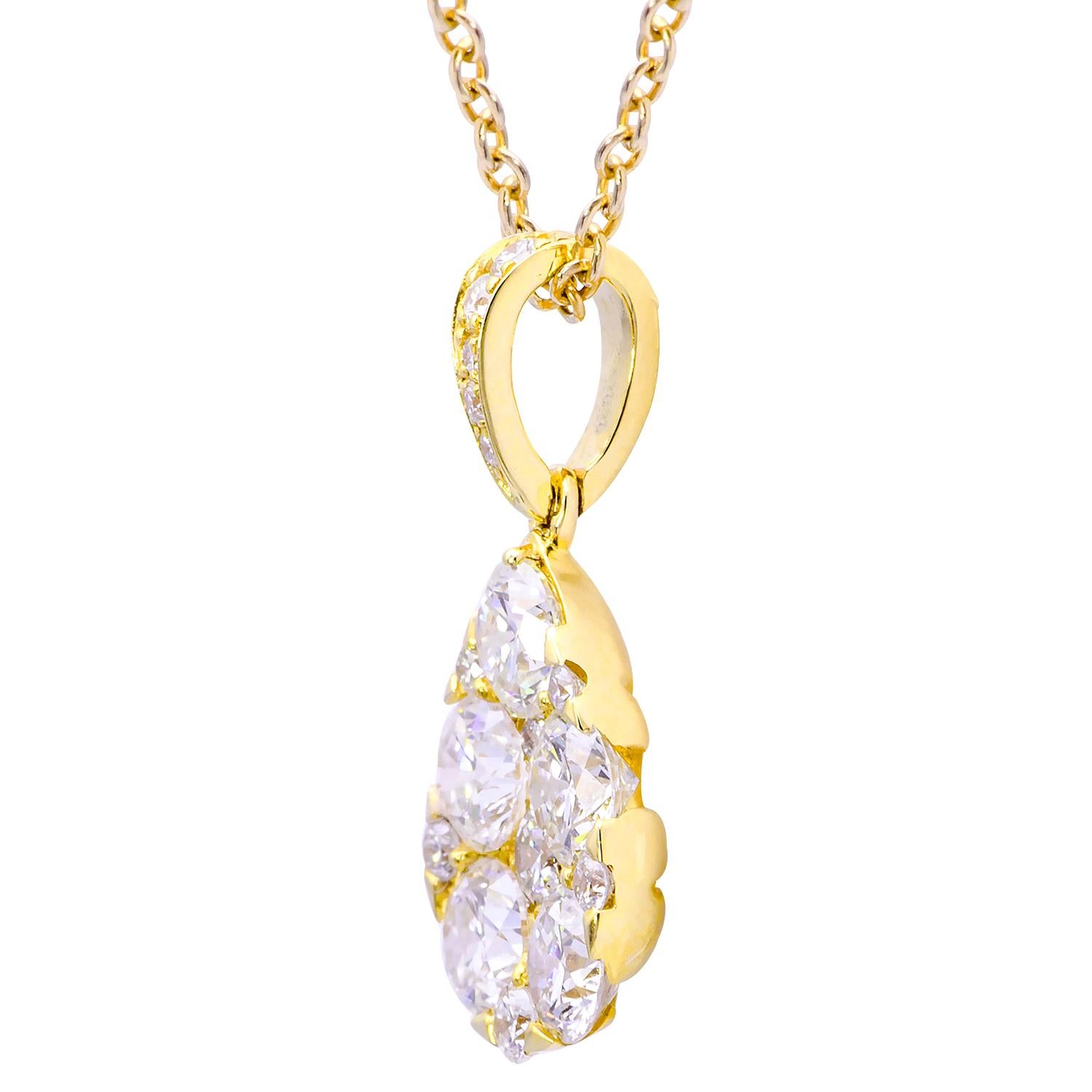 Classic and elegant are the first words that come to mind with this stunning necklace. Set in 1.2 grams of 18 karat yellow gold are 5 large diamonds surrounded by 12 smaller diamonds to make a lovely pearl-shaped cluster hanging from a