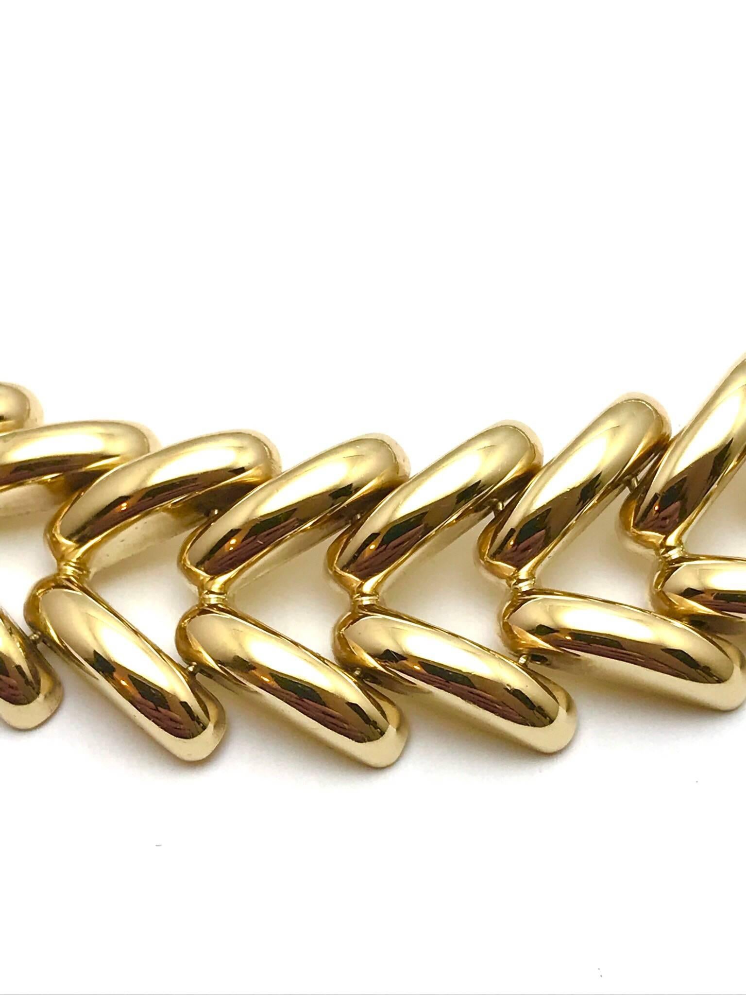 This is a fantastic piece for a night out!  A 15.50 inch 14 karat yellow gold collar/choker necklace.  The links are designed in a chevron shape, finished with a high polish to give them a noticeable shimmer.

Hallmark:  585  Italy