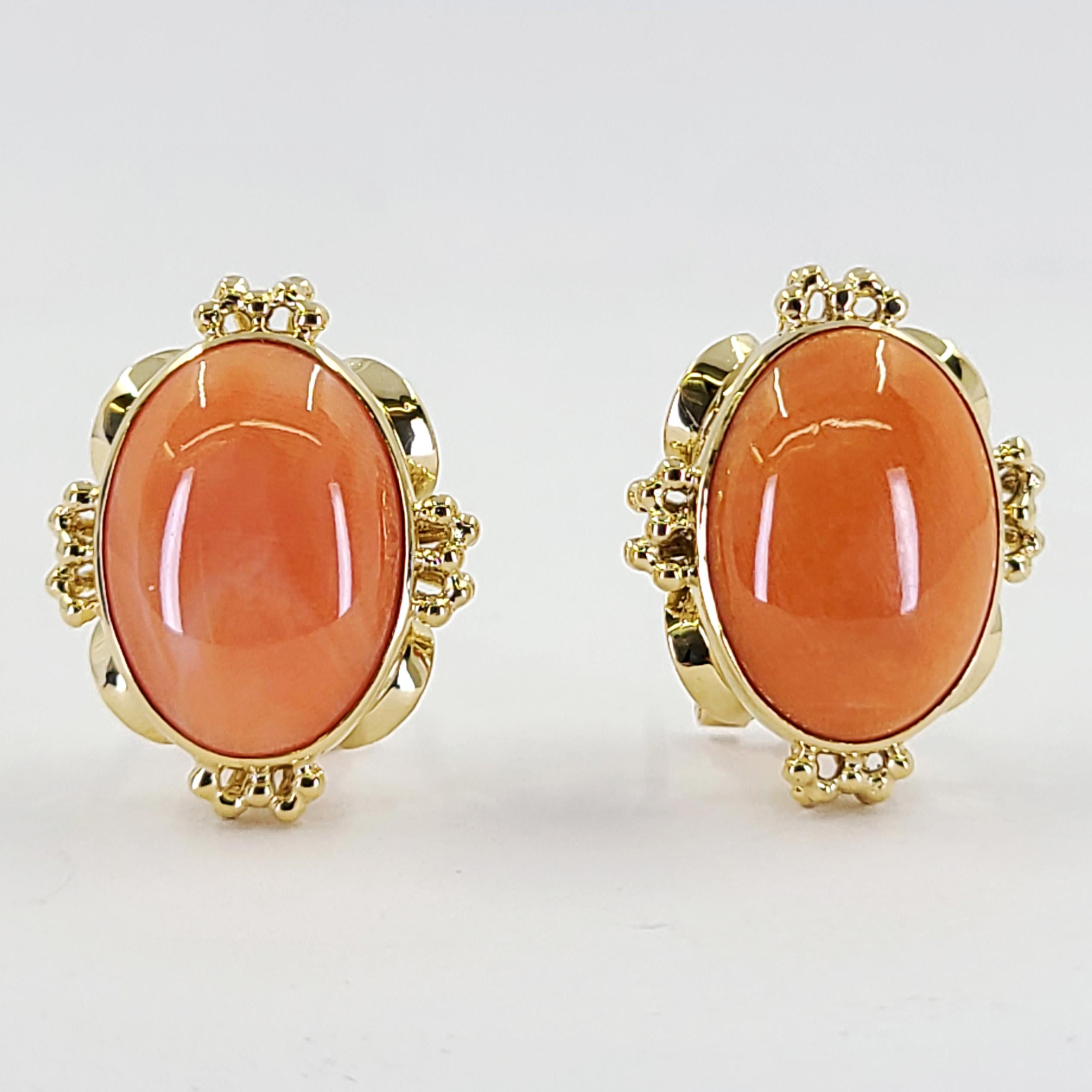 18 Karat Yellow Gold Earrings Featuring 2 Bezel Set 17mm x 13mm Oval Corals. Pierced Post With Omega Clip Back. Finished Weight Is 12.5 Grams.