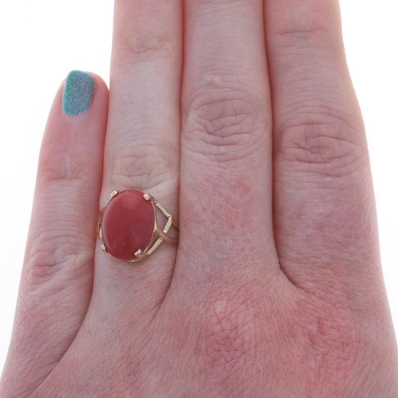 Size: 7
Sizing Fee: Up 2 sizes for $35 or Down 1 size for $35

Metal Content: 14k Yellow Gold

Stone Information

Natural Coral
Cut: Oval Cabochon

Style: Cocktail Solitaire Bypass

Measurements

Face Height (north to south): 9/16
