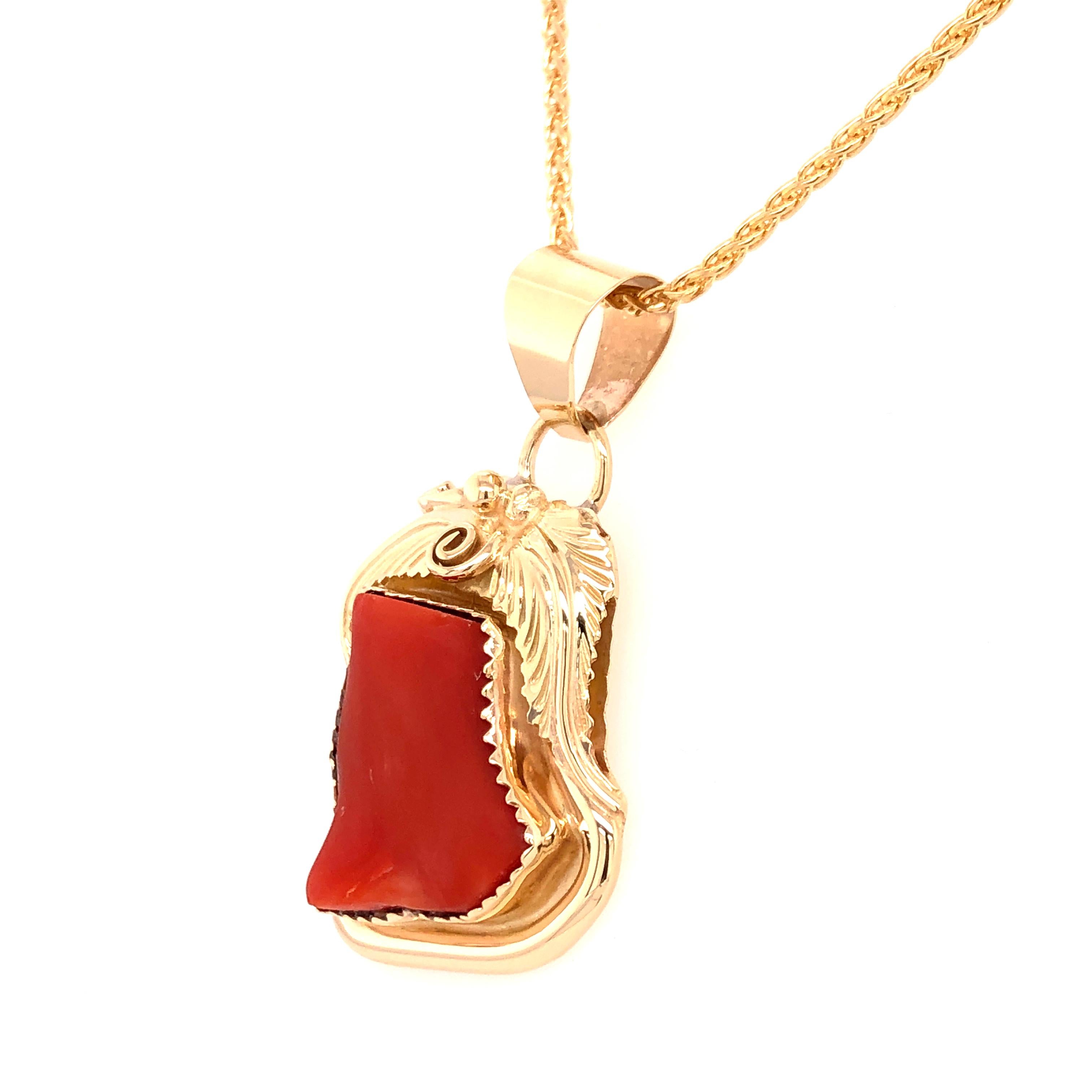 A perfect gift for your Boho chic heart. The design of this pendant is based on the organic shape of the bezel set red coral. The floral motif of the 14K yellow gold further defines the natural design. 

The pendant rests on a 17.5