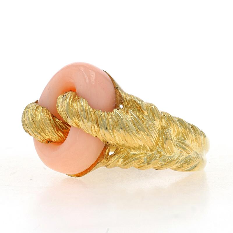 Size: 10
Please contact us for a resizing quote

Metal Content: 18k Yellow Gold

Stone Information
Natural Coral
Color: Light Peach

Style: Solitaire
Theme: Woven Knot Link
Features: Smoothly Finished with Textured Detailing

Measurements
Face