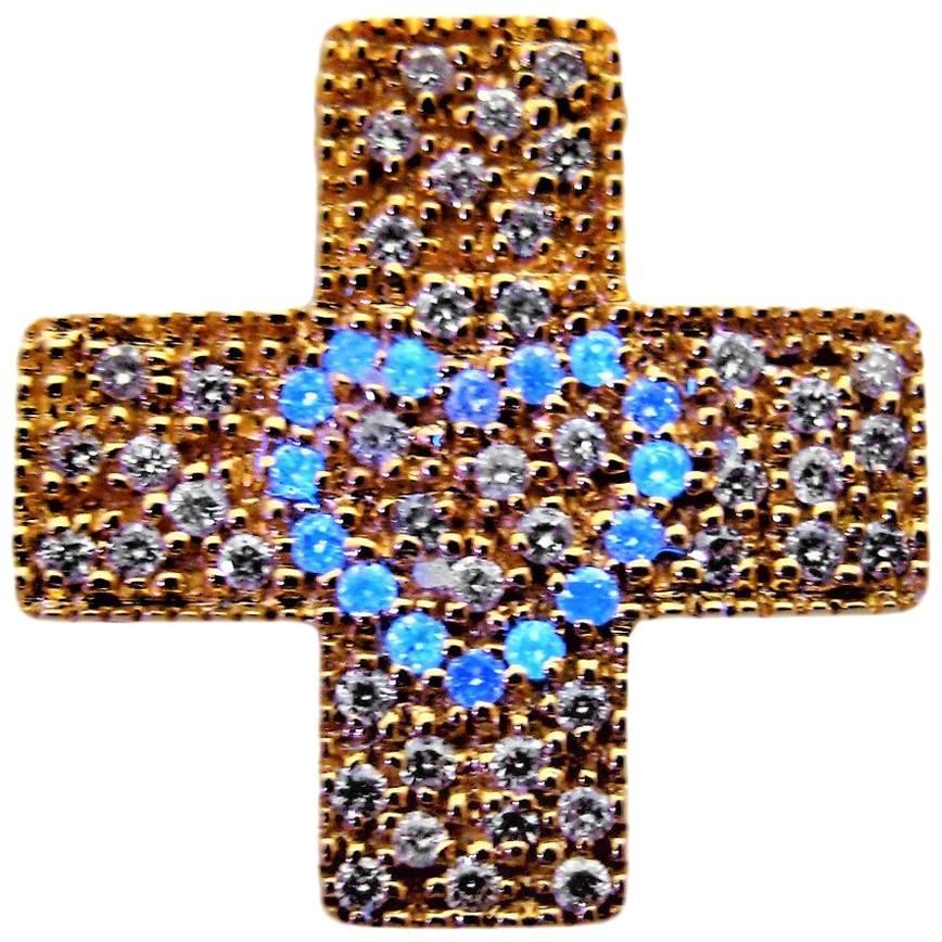 DIAMOND LOVE      
Diamonds scintillations on a yellow gold textured Cross. 
Under a gem light 16 Natural Luminous Diamonds glow as blue shiny stars to reveal the iconic DIAMOND LOVE. 
Total weight of 60 round brilliant-cut diamonds: 0.60 ct.