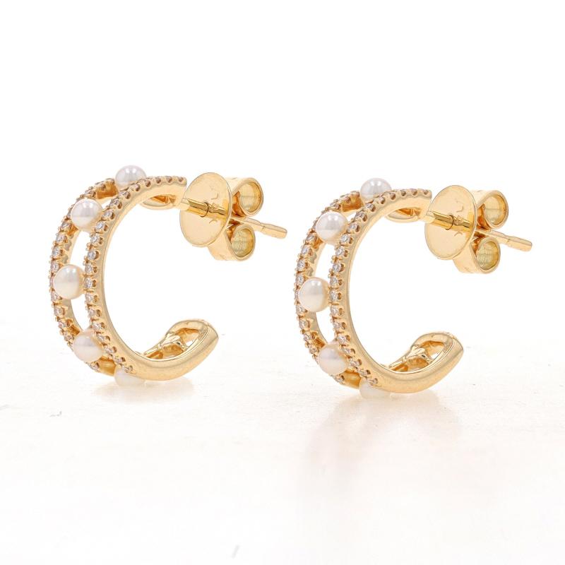 Metal Content: 14k Yellow Gold

Stone Information
Cultured Freshwater Pearls
Color: White

Natural Diamonds
Carat(s): .17ctw
Cut: Single
Color: G
Clarity: VS1 - VS2

Total Carats: .17ctw

Style: Half-Hoop
Fastening Type: Butterfly Closures
Features: