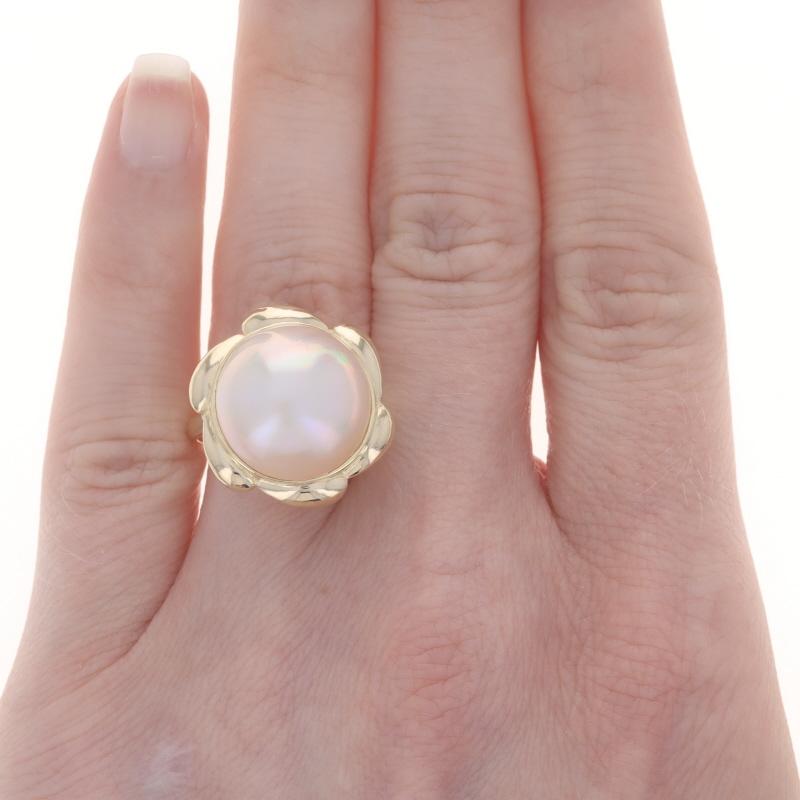 Size: 7 3/4
Sizing Fee: Up 3 sizes for $35 or Down 2 sizes for $35

Metal Content: 14k Yellow Gold

Stone Information

Cultured Mabe Pearl
Size: 15mm

Style: Cocktail Solitaire
Theme: Floral

Measurements

Face Height (north to south): 3/4