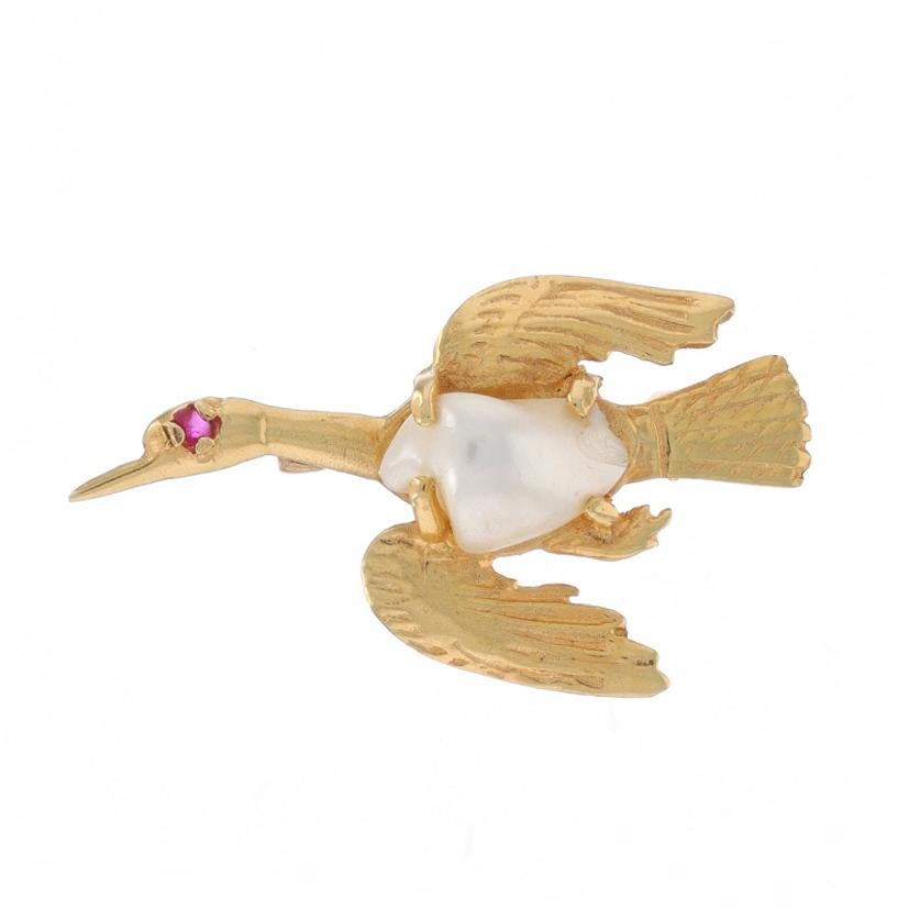 Metal Content: 14k Yellow Gold

Stone Information

Cultured Pearl
Cut: Baroque
Color: White

Natural Ruby
Treatment: Heating
Cut: Round
Color: Pinkish Red
Stone Note: (one small accent)

Style: Brooch
Fastening Type: Hinged Pin and Whale Tail
Theme: