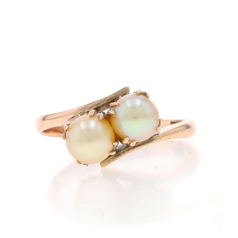 Size: 3 1/4
Sizing Fee: Up 2 1/2 sizes for $30 or Down 1 size for $30

Era: Vintage

Metal Content: 10k Yellow Gold

Stone Information
Cultured Pearls
Size: 4.6mm & 4.7mm

Style: Two-Stone Bypass

Measurements
Face Height (north to south): 5/16