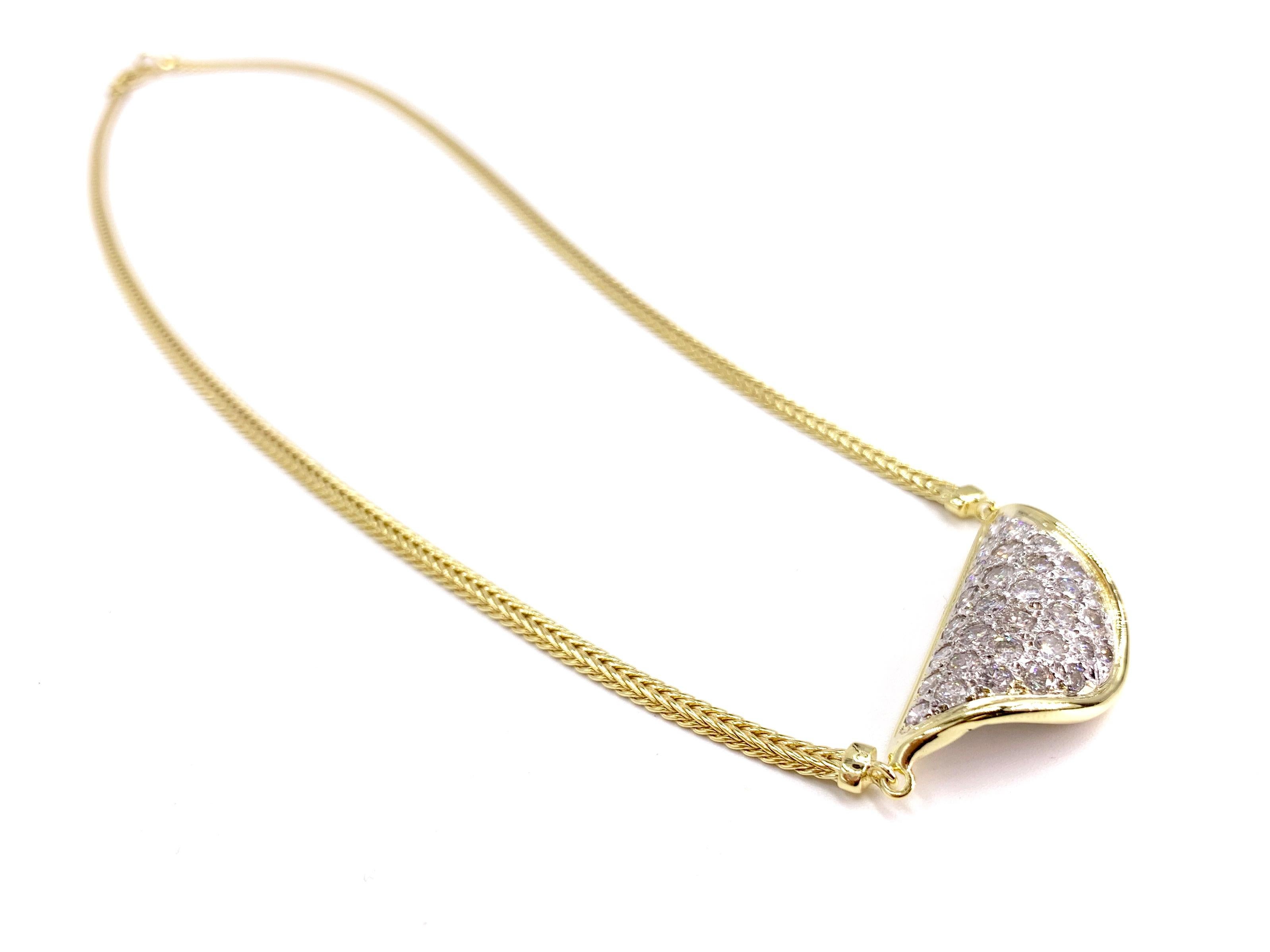 A wearable and fashionable vintage 14 karat yellow gold stationary curved diamond plate necklace featuring approximately 1.50 carats of round brilliant diamonds at approximately G color, SI1 clarity. Diamonds are expertly pave set in white gold for