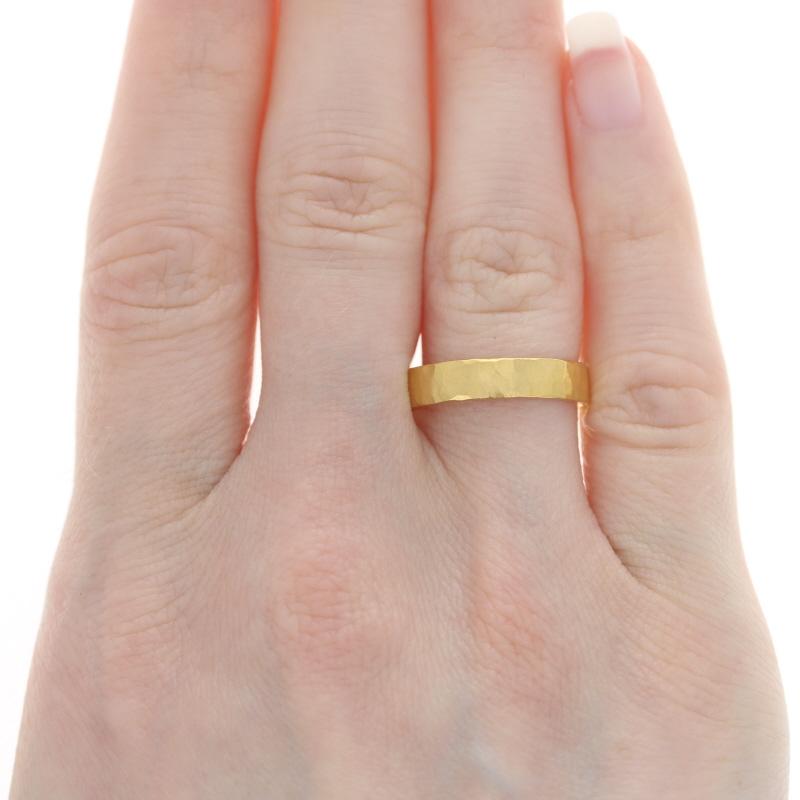 Size: 7
Please contact us for a re-sizing quote.

Metal Content: 24k Yellow Gold

Style: Custom Wedding Band without Stones
Features: Hammered Exterior with Smoothly Finished Interior

Measurements
Face Height (north to south): 3/16