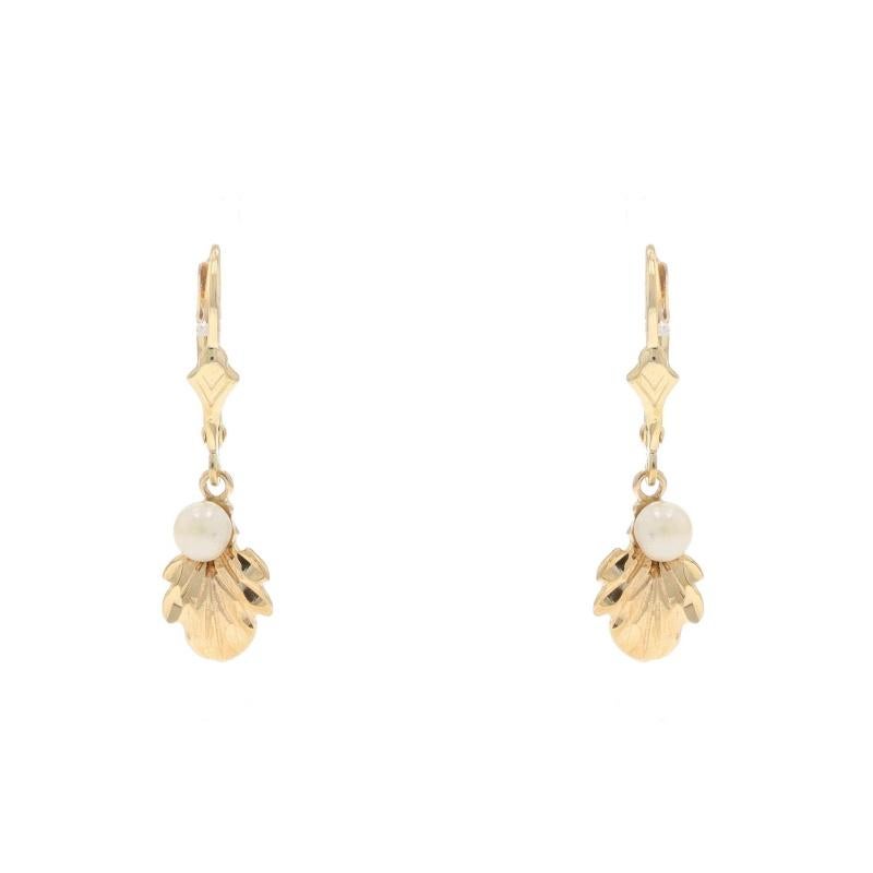 Metal Content: 14k Yellow Gold

Color: Cream
Size: 3.8mm & 3.9mm

Style: Dangle
Fastening Type: Leverback Closures
Theme: Leaves
Features: Etched Detailing

Measurements

Tall: 1 3/32