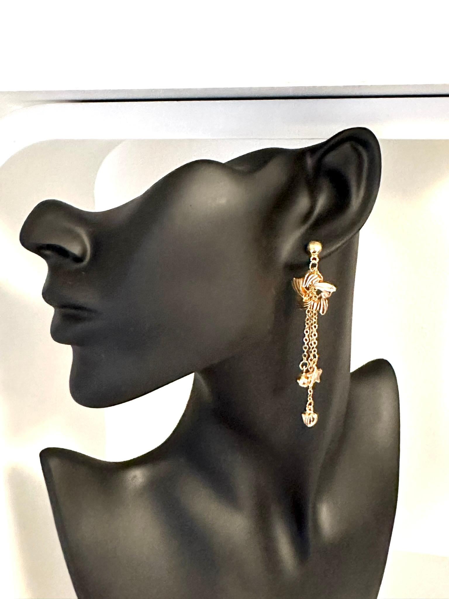 These Yellow Gold Dangle Star-Shaped Earrings are a celestial delight, radiating beauty and elegance. Crafted from stunning 21kt yellow gold, these earrings possess a rich and luxurious hue that adds warmth and sophistication to any ensemble.

The