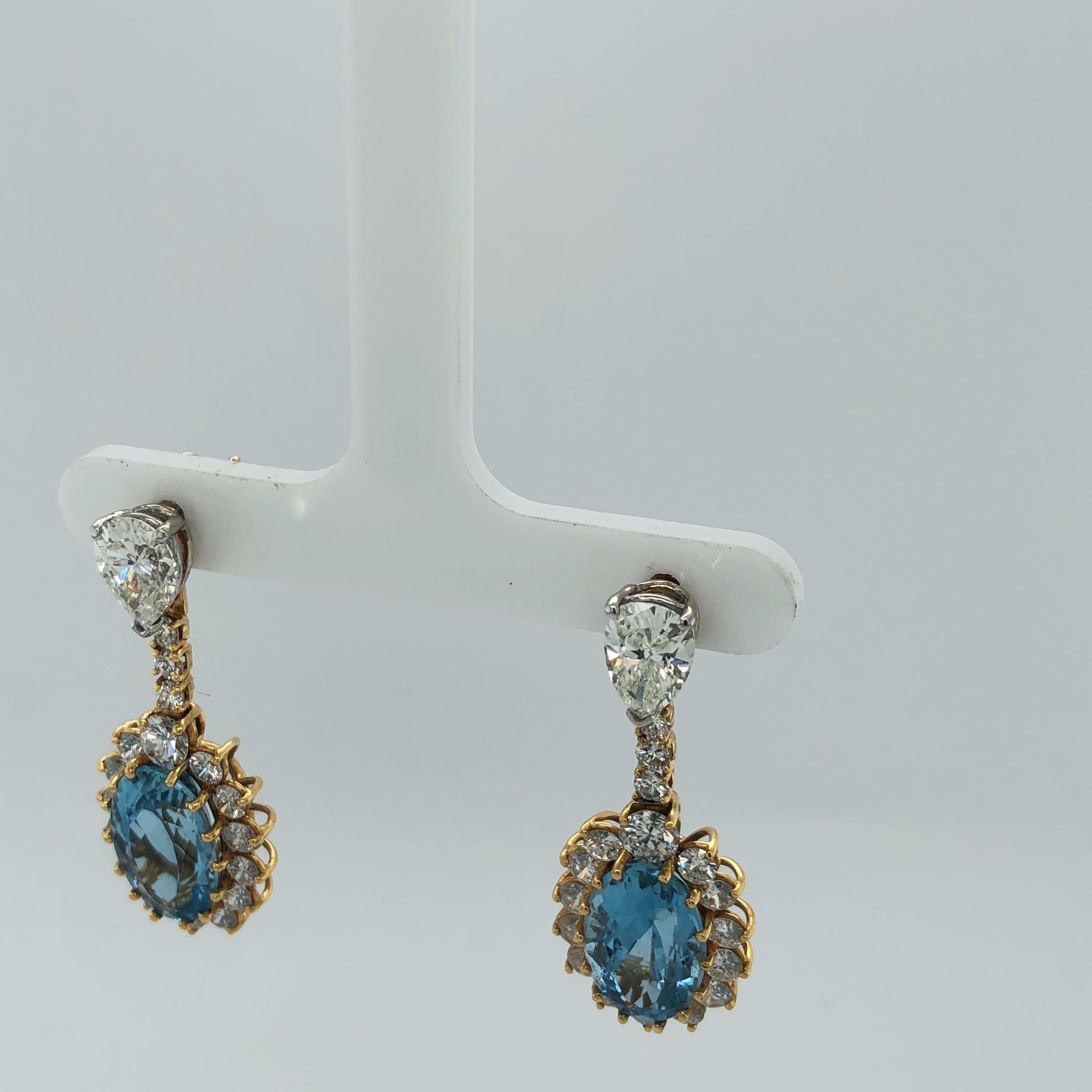 One pair of lady's 14K Yellow Gold Diamond and Aquamarine Earrings containing 2 Pear shape diamonds with 2.40 carats total weight. Drops Contain 10 full cut diamonds .81 carat total weight with 2 oval Aquamarine stones 8.8 carats total weight and 26