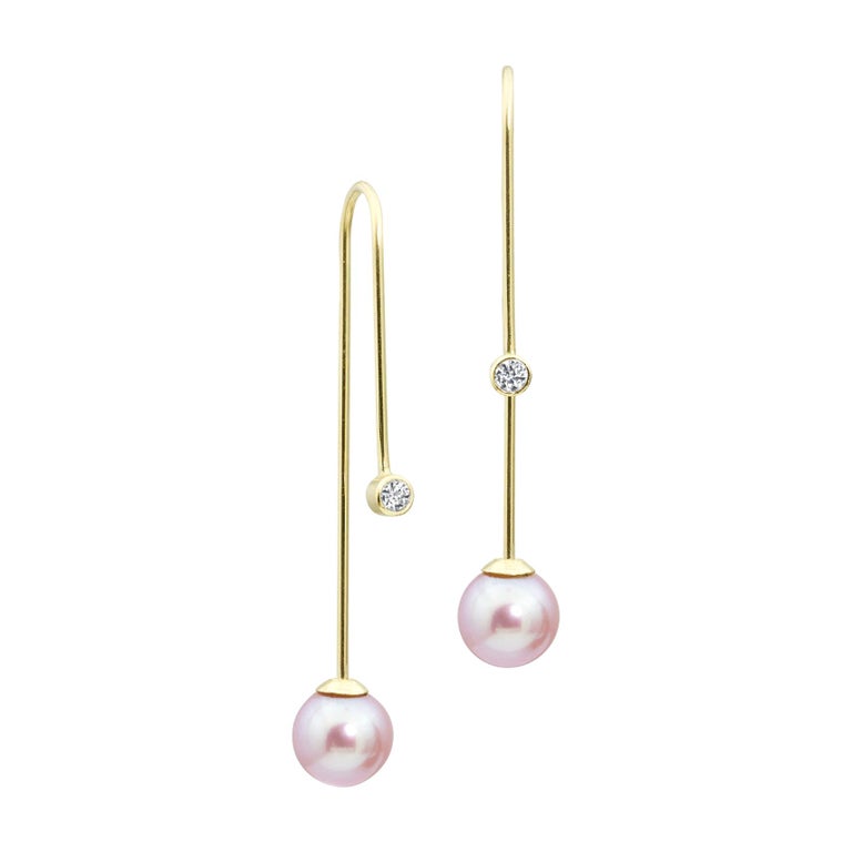 This Diamond and Pearl Gold piece is a whole new way of wearing an earring. A 2.5mm conflict-free diamond and an 8mm pink pearl hang on a solid 14k gold earring that comfortably threads through the ear.  To wear this earring, the pearl screws off,