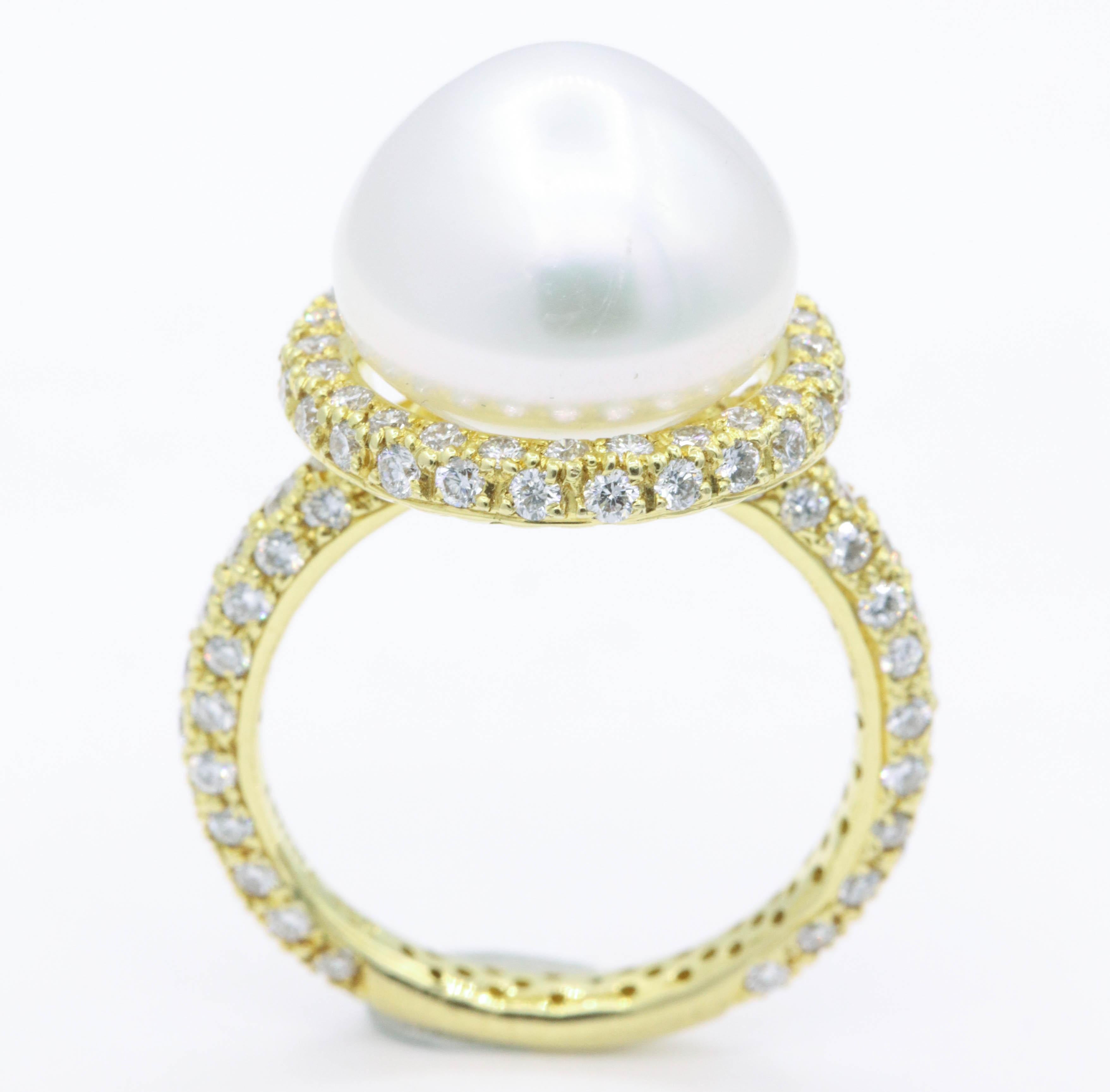 This 18k yellow gold ring features one center pearl, 13 mm, flanked with 118 round brilliants weighing 1.57 carats. 
Color: G
Clarity: SI1

Beautifully made!