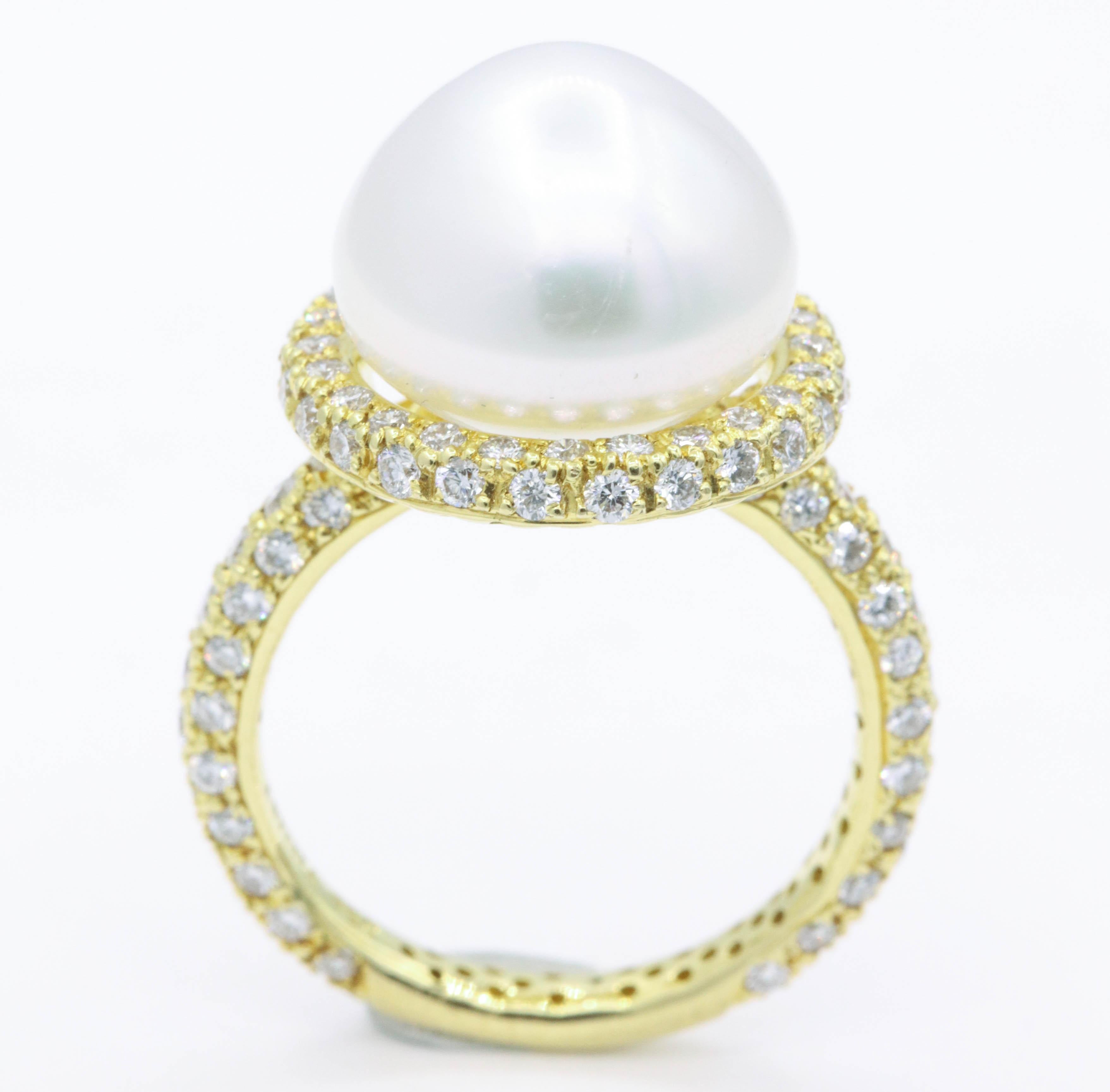 This 18k yellow gold ring features one center pearl, 13 mm, flanked with 118 round brilliants weighing 1.57 carats. 
Color: G-H
Clarity: SI