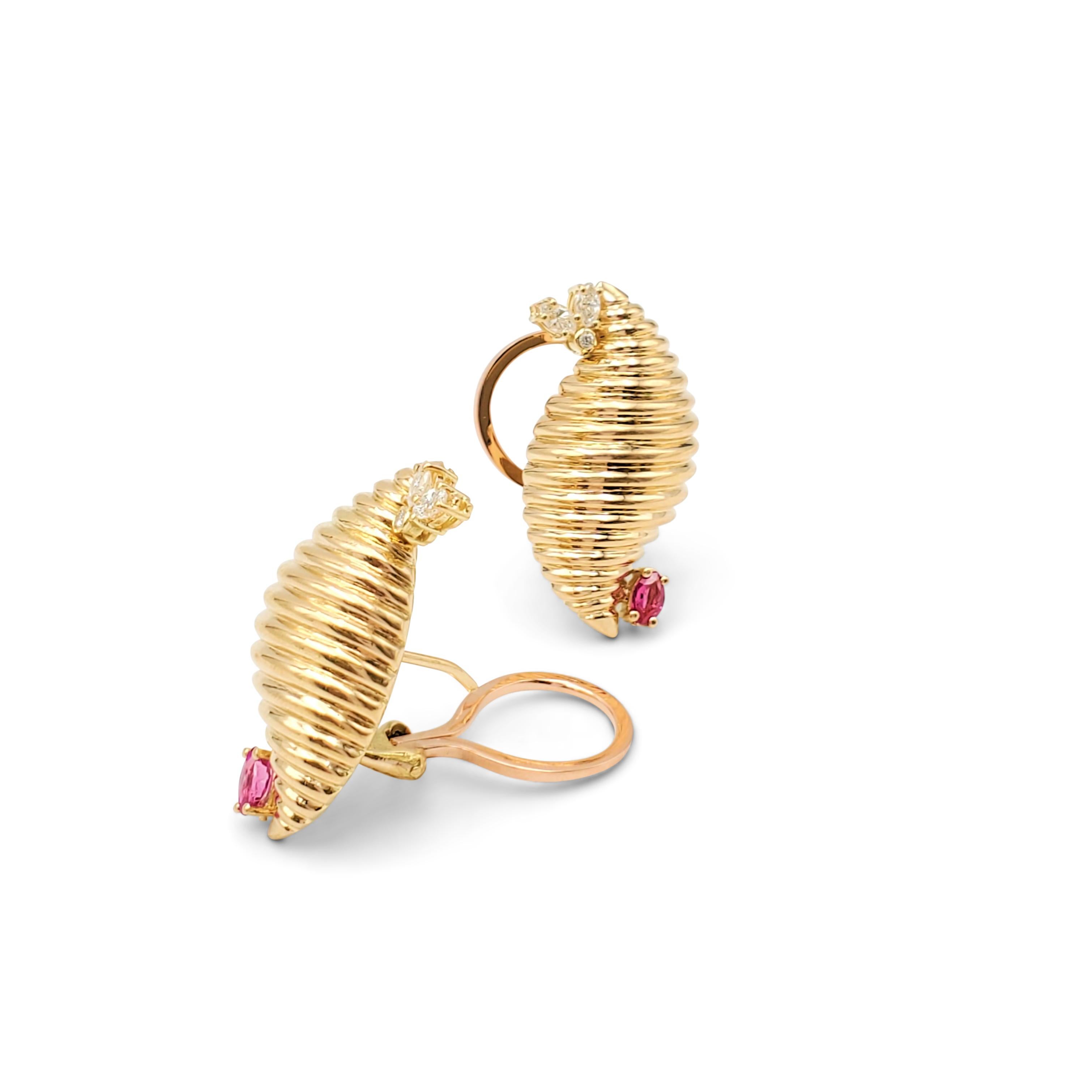 Textured 18 karat yellow gold earrings set with round and marquise-shaped diamonds (H-I color, VS-SI clarity) weighing an estimated 0.30 carats total weight. Lively oval-shaped rubies are set at the opposing side of the scroll. Earrings backs are