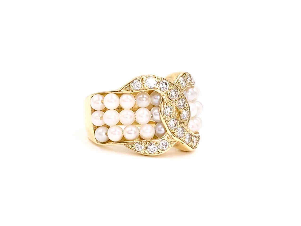 14 Karat yellow gold wide interlocking design ring featuring .50 carat of round brilliant diamonds and three rows of lustrous round ivory seed pearls. Diamond quality is approximately G color, SI1 clarity. Ring has a width of 14mm and tapers to 4mm