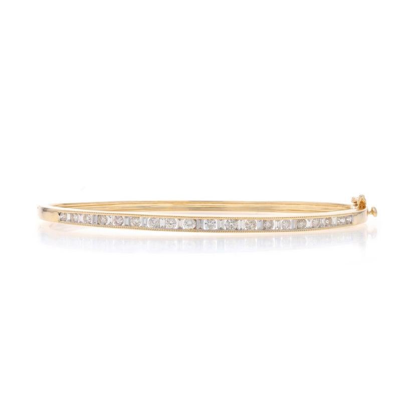 Metal Content: 14k Yellow Gold & 14k White Gold

Stone Information

Natural Diamonds
Carat(s): 1.00ctw
Cut: Round Brilliant & Baguette
Color: K - L
Clarity: SI1 - SI2

Total Carats: 1.00ctw

Style: Bangle
Fastening Type: Tab Box Clasp with One Side