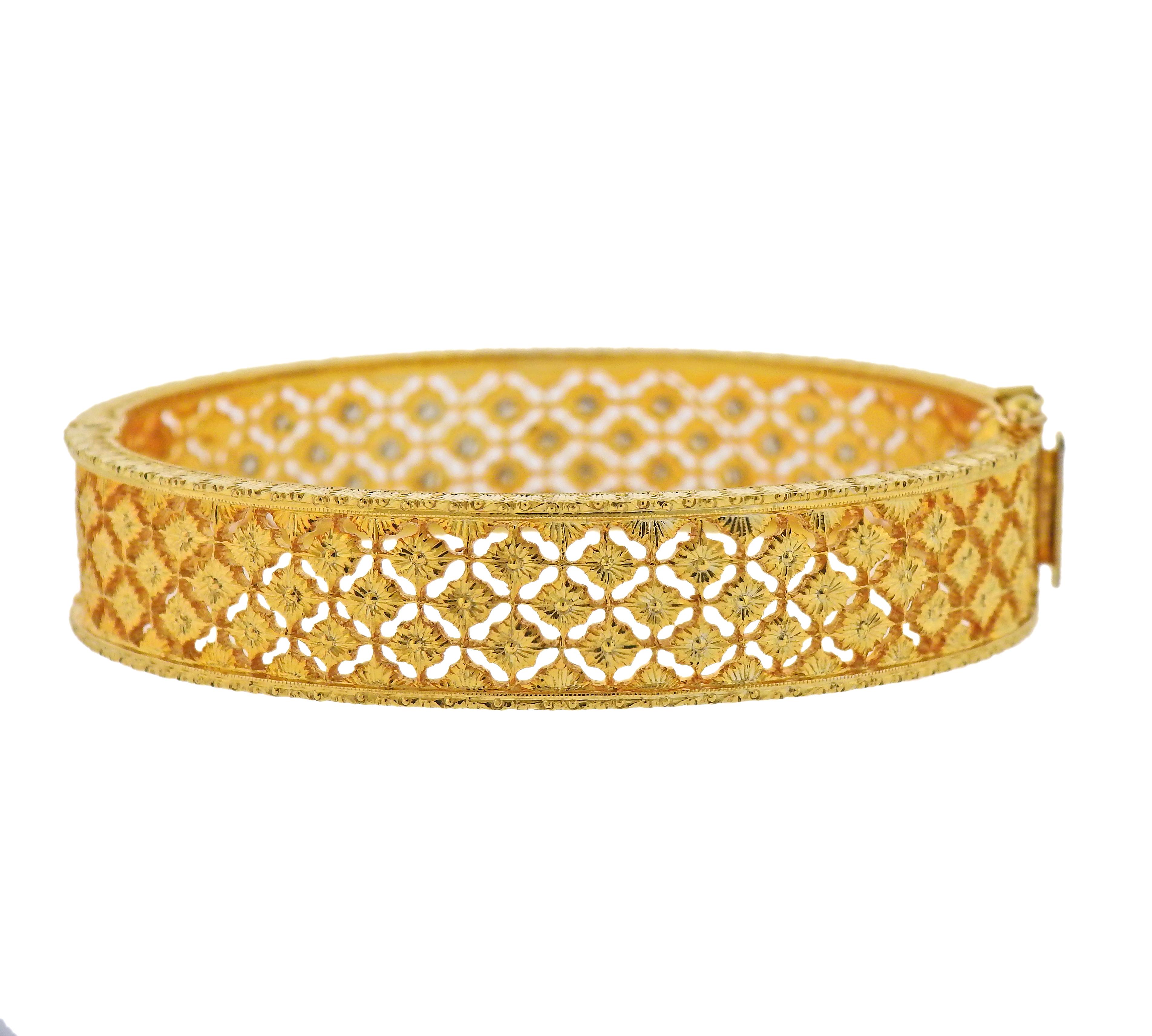 18k yellow gold openwork bangle bracelet with approx. 1.25ctw in diamonds.  Bracelet will fit approx. 6.5-6.75