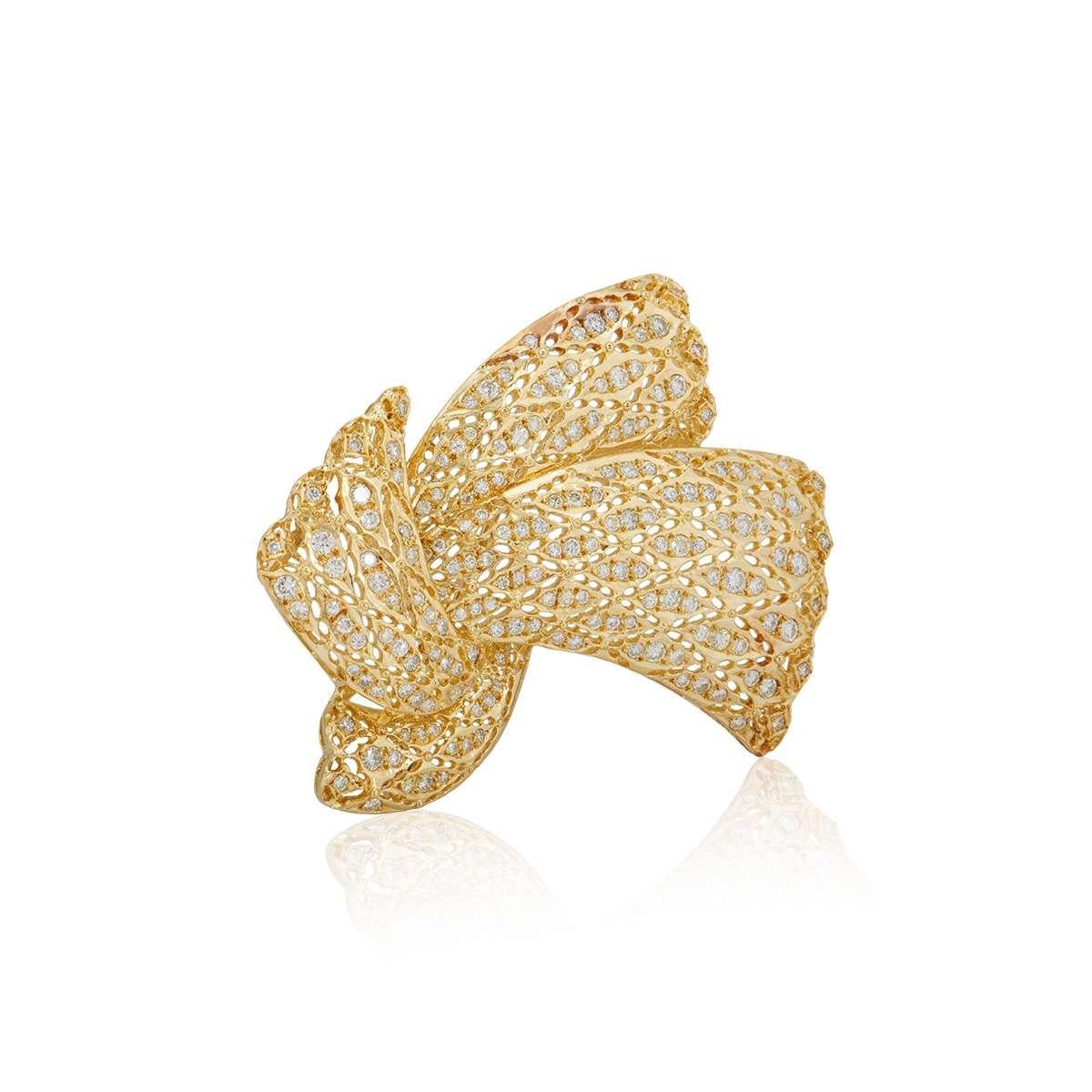 An 18k yellow gold diamond Bow brooch. The brooch is set with round brilliant cut diamonds, totalling approximately 2.71ct. The brooch measures 4.5cm in width and 5cm in length and has a pin closure to the reverse. The brooch has a gross weight of