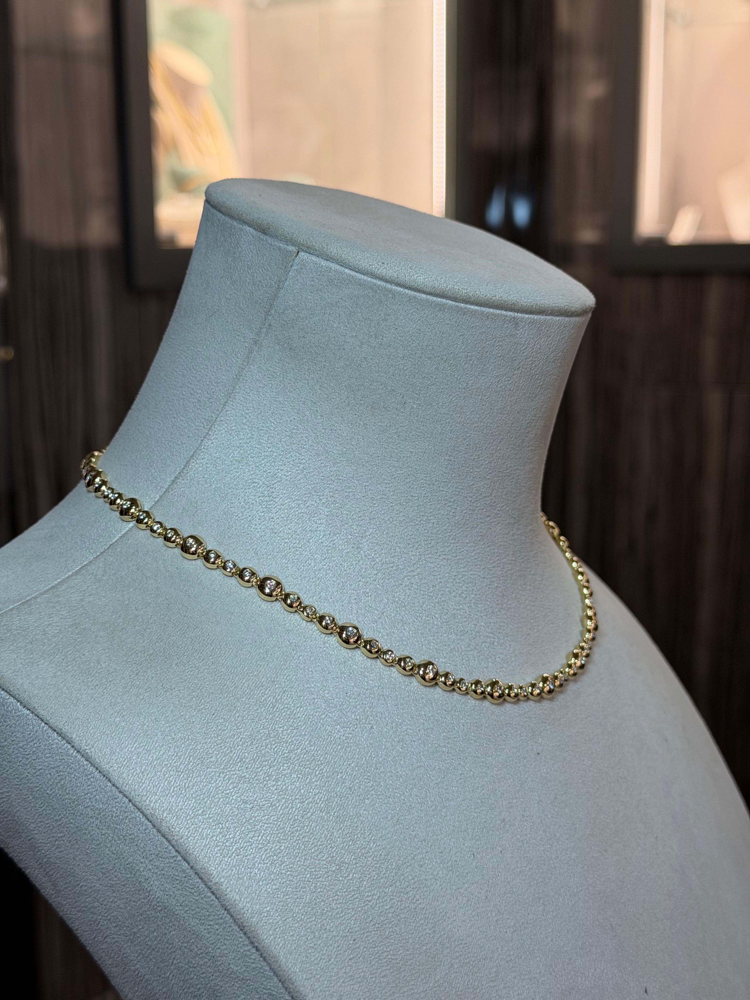 A contemporary statement of timeless elegance, this exquisite full collier necklace is a true celebration of refined craftsmanship and modern luxury. Meticulously created in rich 18ct yellow gold, it features a flowing sequence of softly rounded