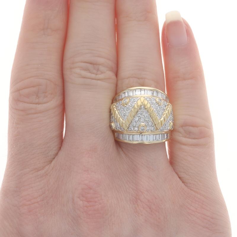 Size: 6

Metal Content: 18k Yellow Gold & 18k White Gold

Stone Information

Natural Diamonds
Carat(s): 2.40ctw
Cut: Round Brilliant & Baguette
Color: F - G
Clarity: SI1 - SI2 / VS1 - VS2

Style: Cluster Dome Cocktail Band

Measurements

Face Height