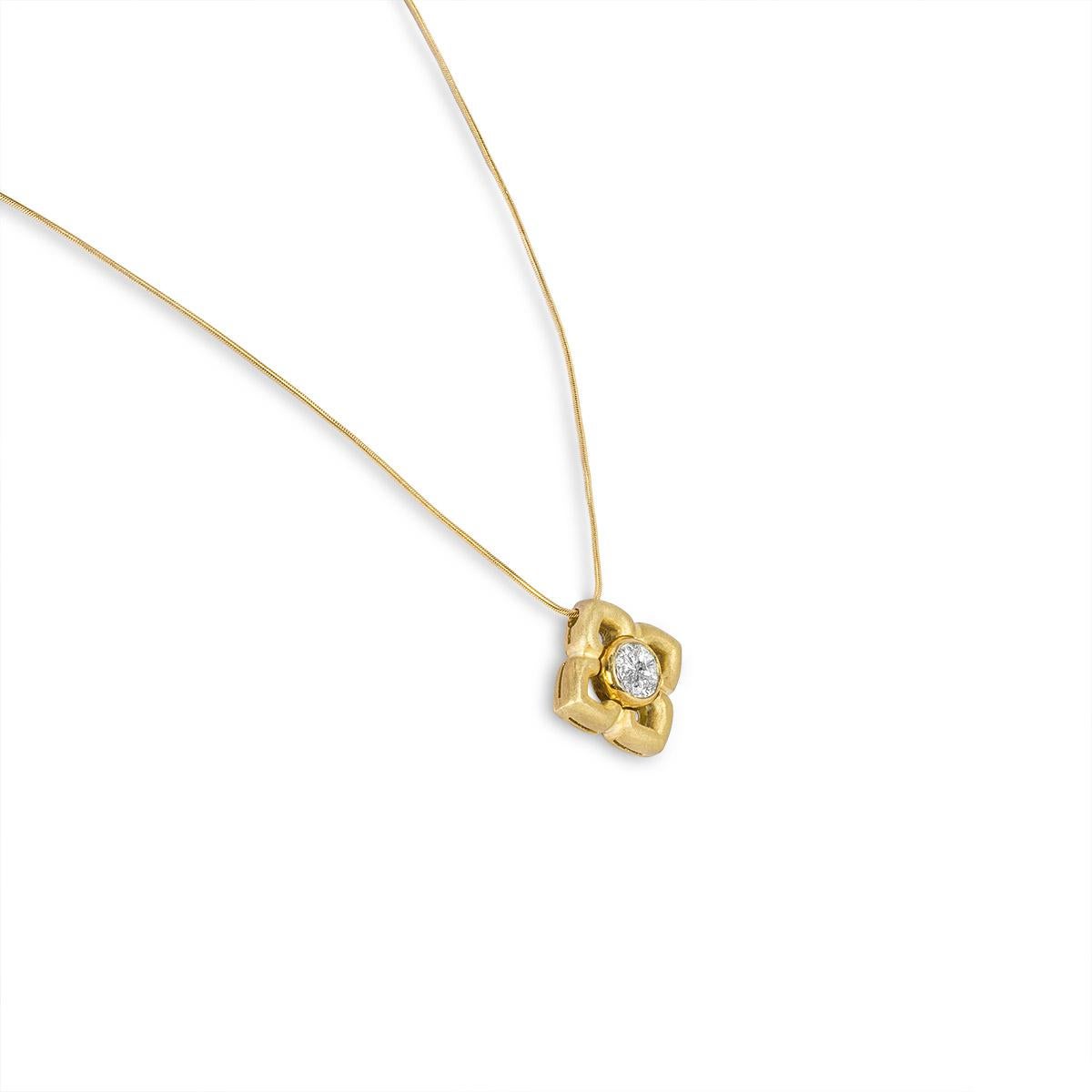 A unique 18k yellow gold diamond pendant. The pendant features a brushed gold floral design set to the centre with a cluster of diamonds in the shape of a circle. The 4 shield shaped diamonds have an approximate total weight of 1.00ct, G-H colour