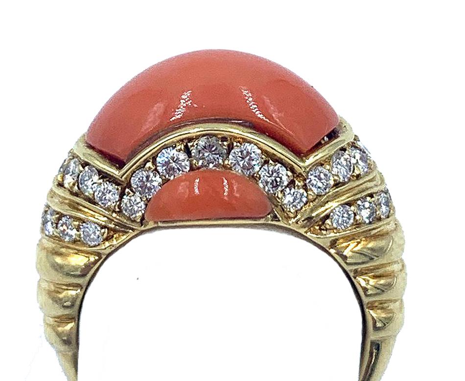 A lovely yellow gold, diamond and natural coral ring beautifully designed by Pichiotti, providing a stunningly fabulous and tastefully complementing backdrop to the astounding color and gracefully smooth shape of the spotless coral stone.