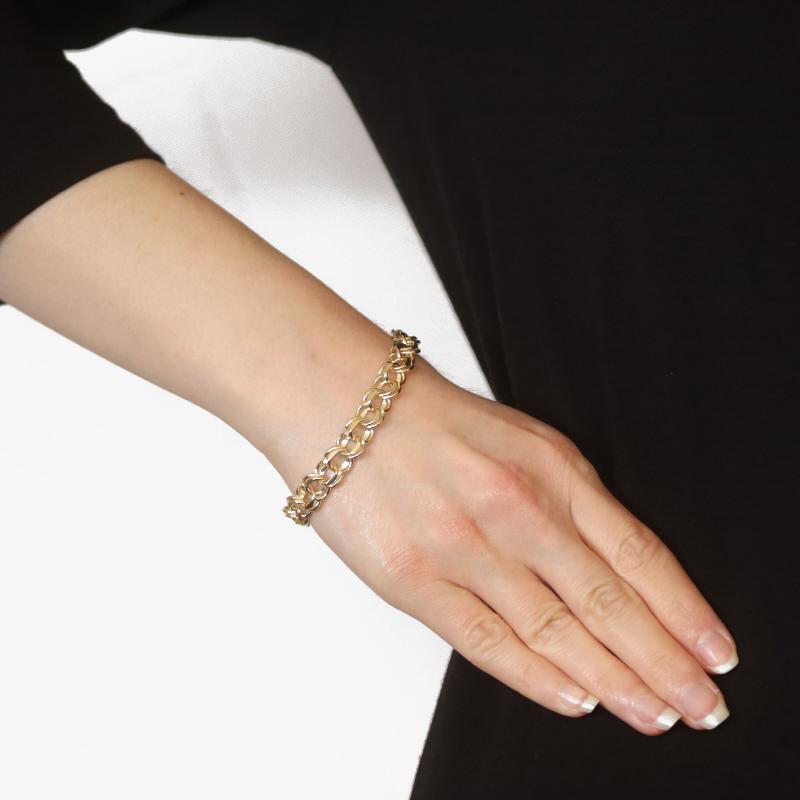 Metal Content: 10k Yellow Gold

Style: Starter Charm
Chain Style: Diamond Cut Double Curb
Bracelet Style: Chain
Fastening Type: Tab Box Clasp with One Side Safety Clasp

Measurements

Length: 7 1/2