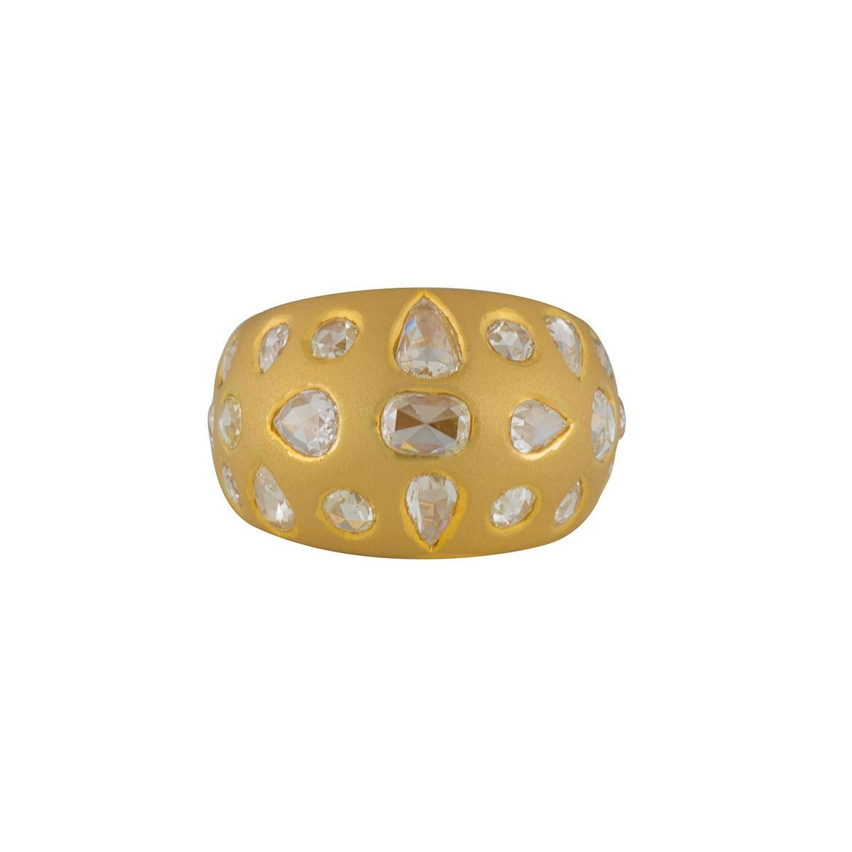 A unique 18k yellow gold diamond bombe dress ring.  The ring is set with 22 varied rose cut diamonds scattered across the front of the ring in a rubover setting with a total diamond weight of approximately 2.91ct, G colour and VS clarity. The ring