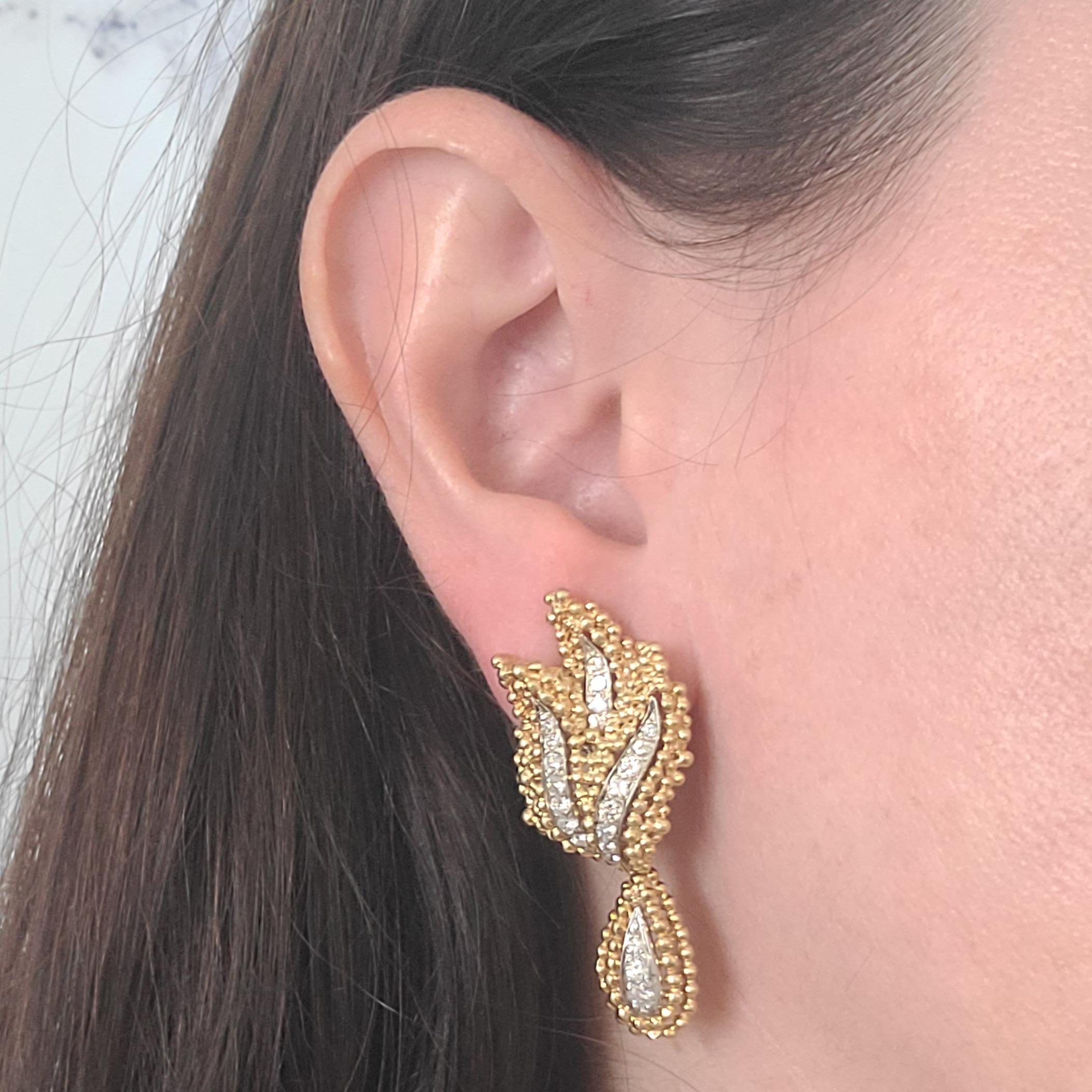 18 Karat Yellow Gold Winged Earrings With Dangling Drop Featuring 42 Round Brilliant Cut Diamonds Of VS Clarity & G Color Totaling Approximately 1.00 Carat. Pierced Post With Omega Clip Back; Post Can Be Removed Upon Request. Finished Weight Is 20