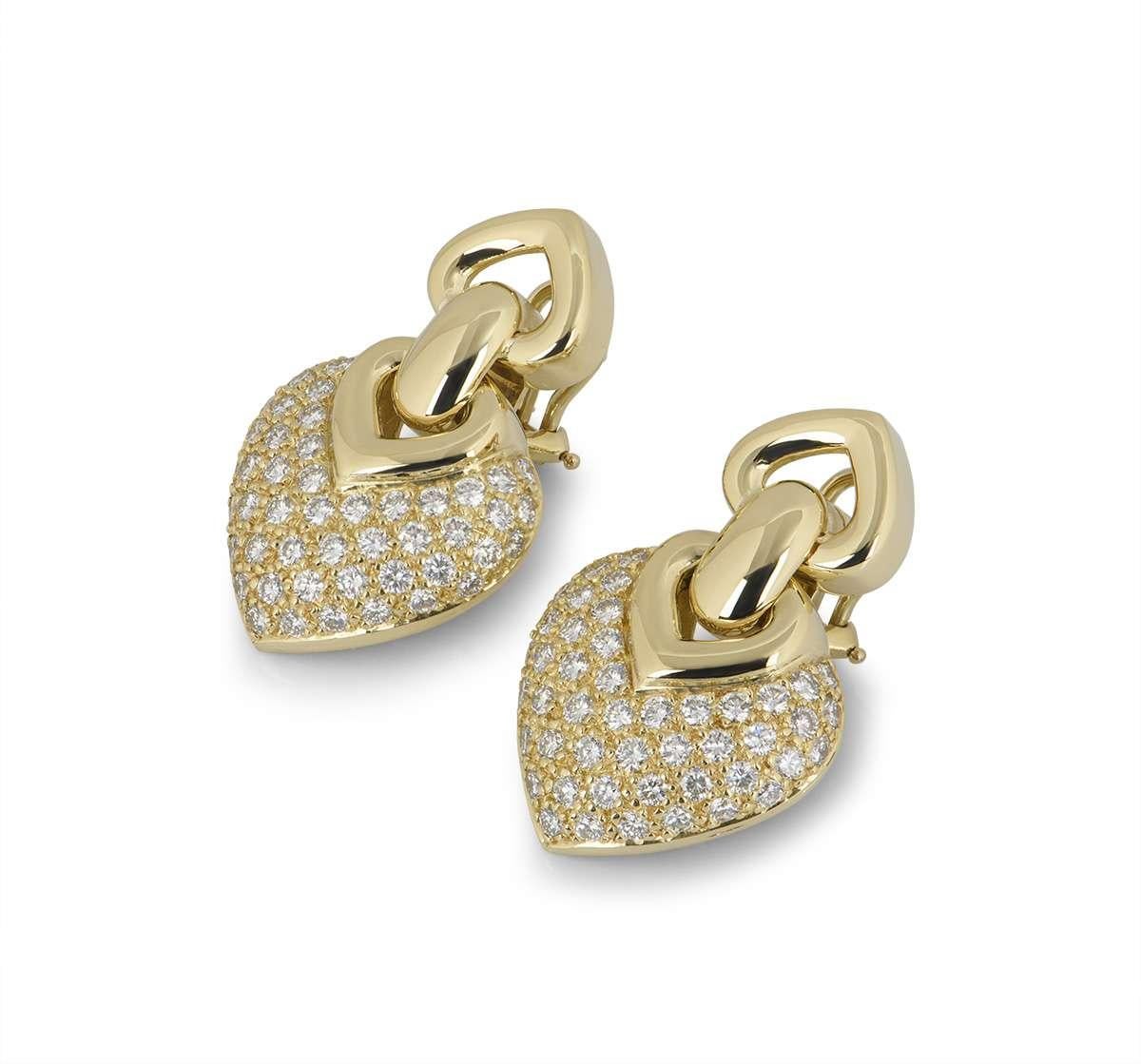 A beautiful pair of 18k yellow gold diamond earrings. The earrings feature a heart shaped motif pave set with round brilliant cut diamonds, totalling approximately 2.40ct. The earrings measure 3.4cm in length and feature post and hinge clip