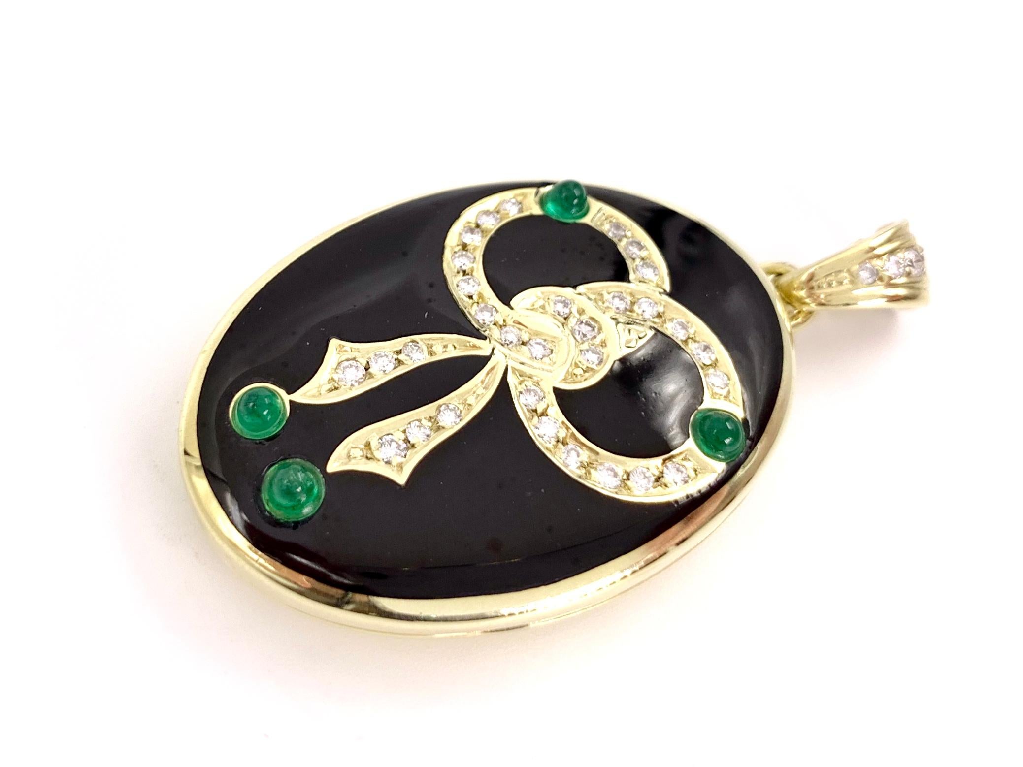 14 Karat yellow gold oval vintage bow locket featuring .40 carats of round brilliant diamonds, four vivid cabochon green emeralds and polished, smooth black enamel. Diamonds are approximately G color, VS2 clarity. Gold and diamond bale is equipped