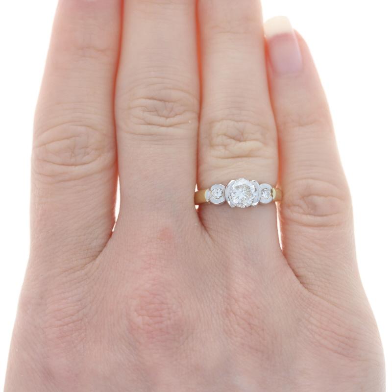 Size: 5
Sizing Fee: Up 2 sizes for $35

Metal Content: 14k Yellow Gold & 18k White Gold

Stone Information

Natural Diamond
Carat(s): 1.00ct
Cut: Round Brilliant
Color: K
Clarity: VS2
Stone Note: (solitaire)

Natural Diamonds
Carat(s): .12ctw
Cut: