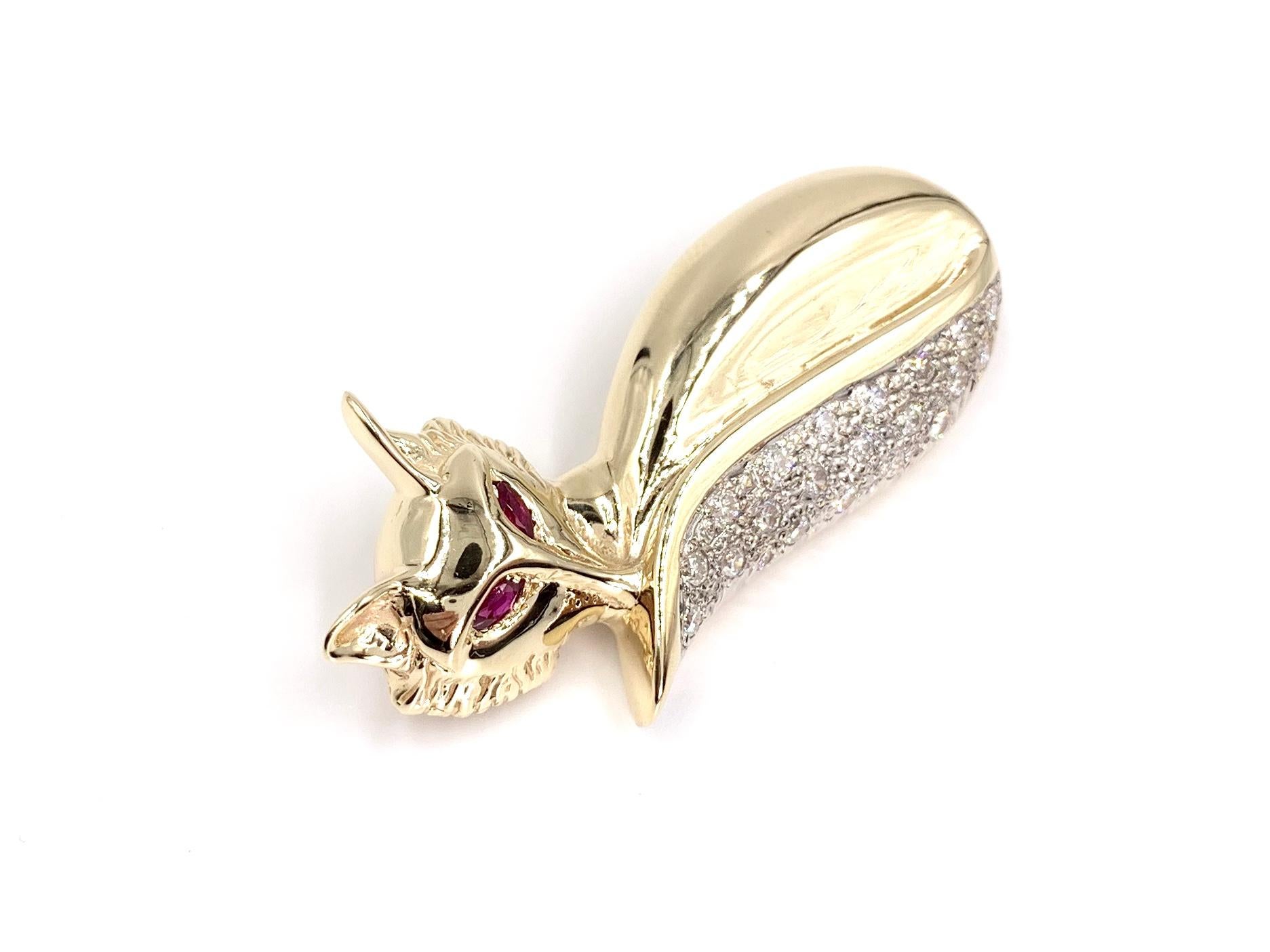 An adorable 14 karat yellow gold fox is curled up with a round brilliant diamond encrusted tail and vivid marquise cut ruby eyes. This slide pendant features 21 diamonds have an approximate total weight of .84 carats at approximately H color, SI1