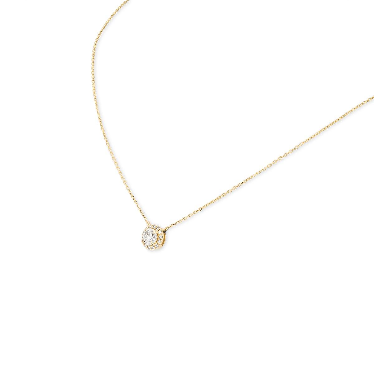 An enchanting 18k yellow gold diamond pendant. Set to the centre of the pendant is a round brilliant cut diamond with an approximate weight of 0.53ct, H colour and SI2 clarity. Accentuating the centre diamond is a halo composed of 14 round brilliant