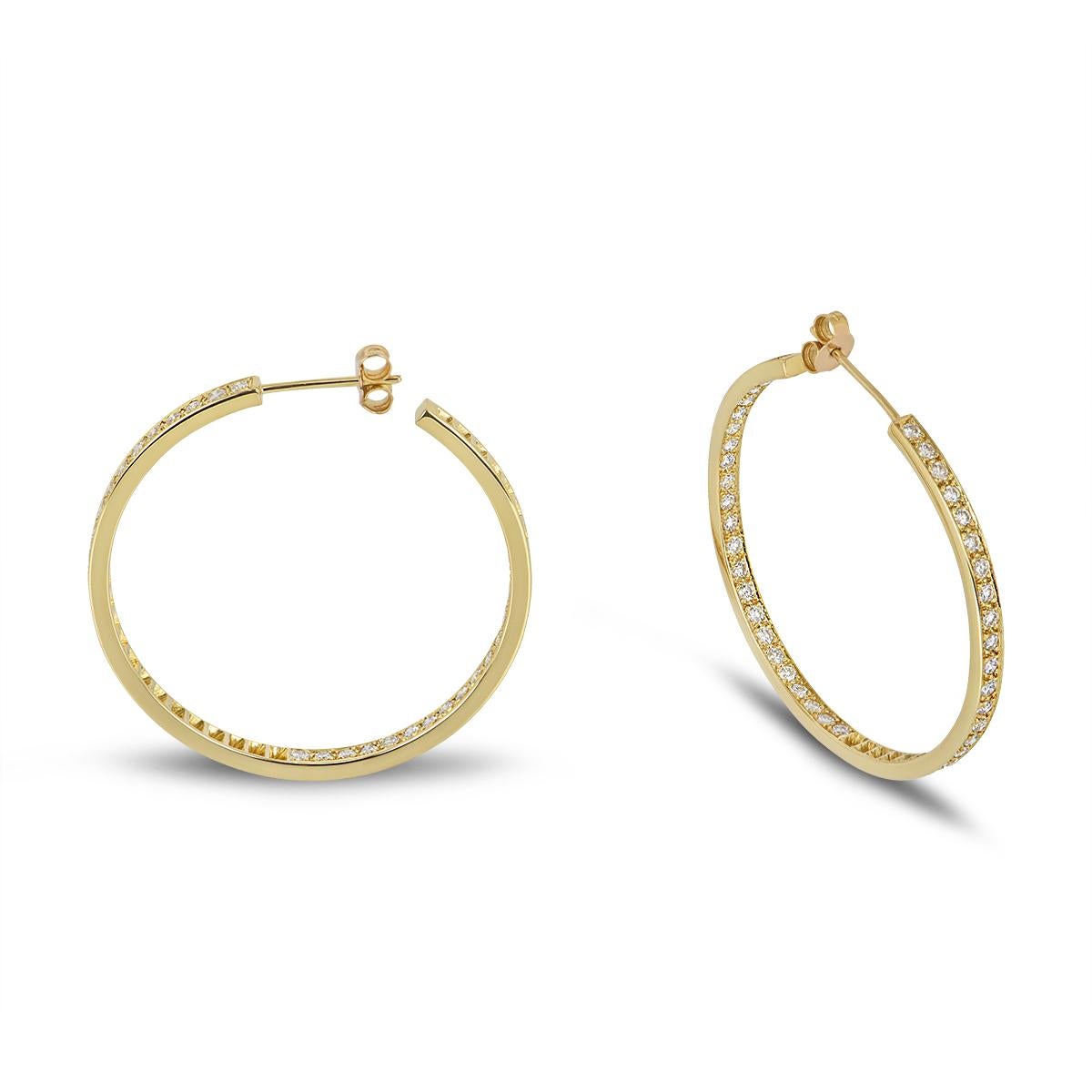 A beautiful pair of 18k yellow gold diamond hoop earrings. The earrings are each set to the front and inner side with 47 round brilliant cut diamonds for a combined total of 2.35ct, H-I colour and VS+ clarity. The earrings measure 2.8mm wide, 4cm in
