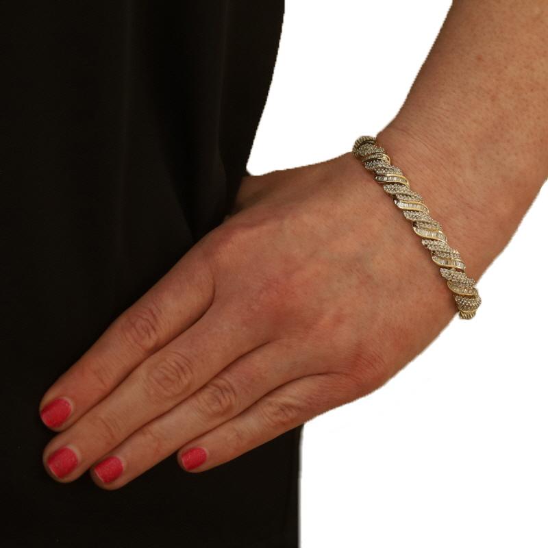 Metal Content: 14k Yellow Gold & 14k White Gold

Stone Information

Natural Diamonds
Carat(s): 5.00ctw
Cut: Single & Baguette
Color: F - G - H
Clarity: SI1 - I1
Stone Note: carat weight stamped

Total Carats: 5.00ctw

Bracelet Style: