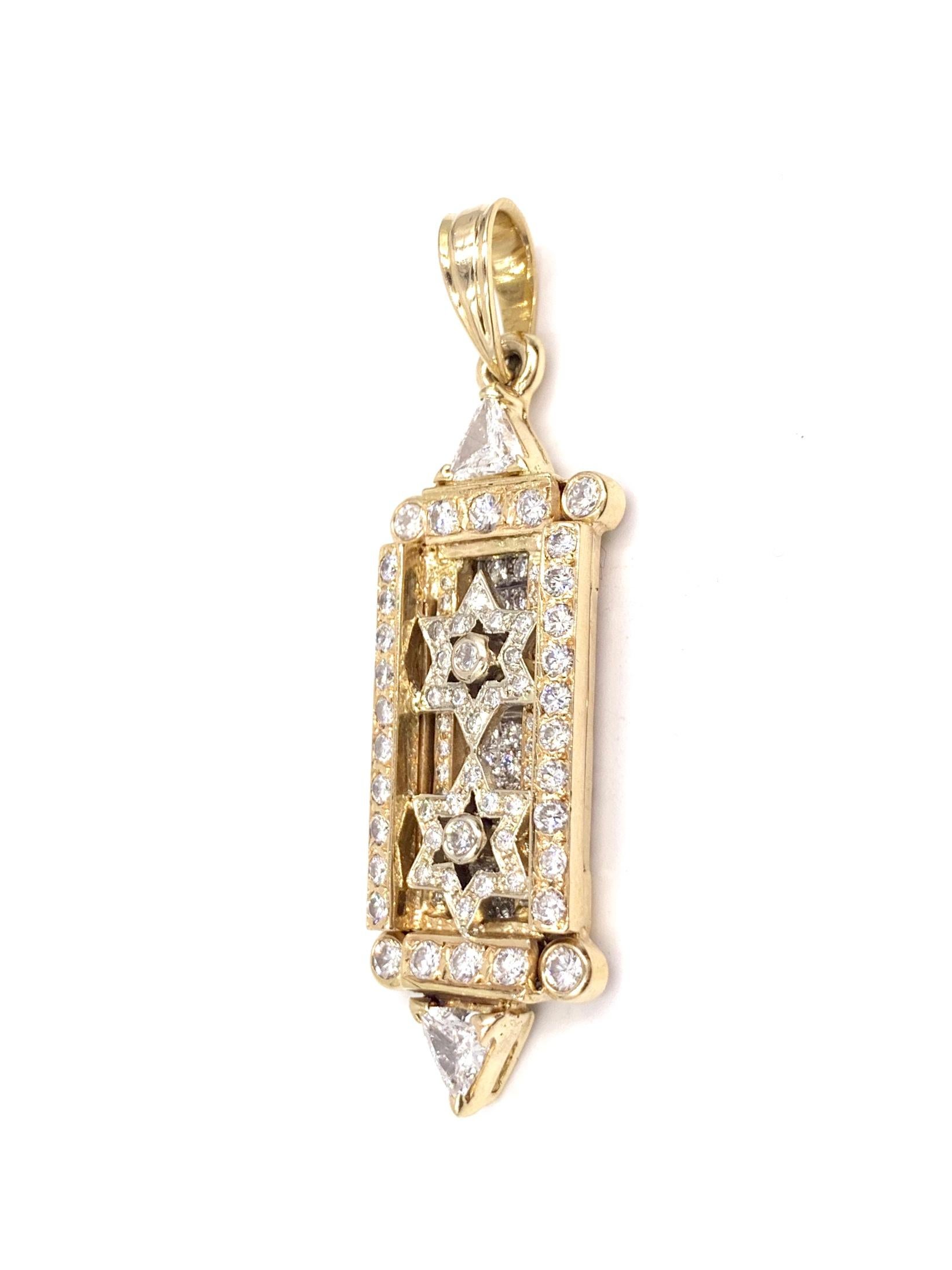 A beautiful, one of a kind diamond Mezuzah Star of David pendant crafted in 14k yellow and white gold. This hand made pendant features approximately 1.38 carats of round brilliant diamonds and two substantial trillion diamonds at approximately .66