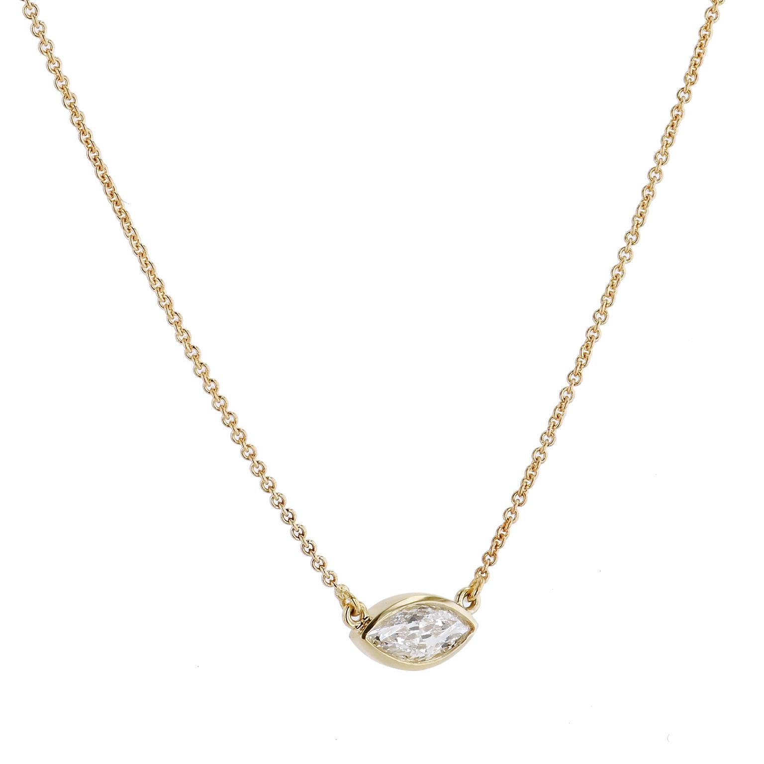 Small accessories still make a big statement. Make yours with this 18 karat yellow gold pendant holding a 0.25 carat marquis cut bezel set diamond(F-S12).