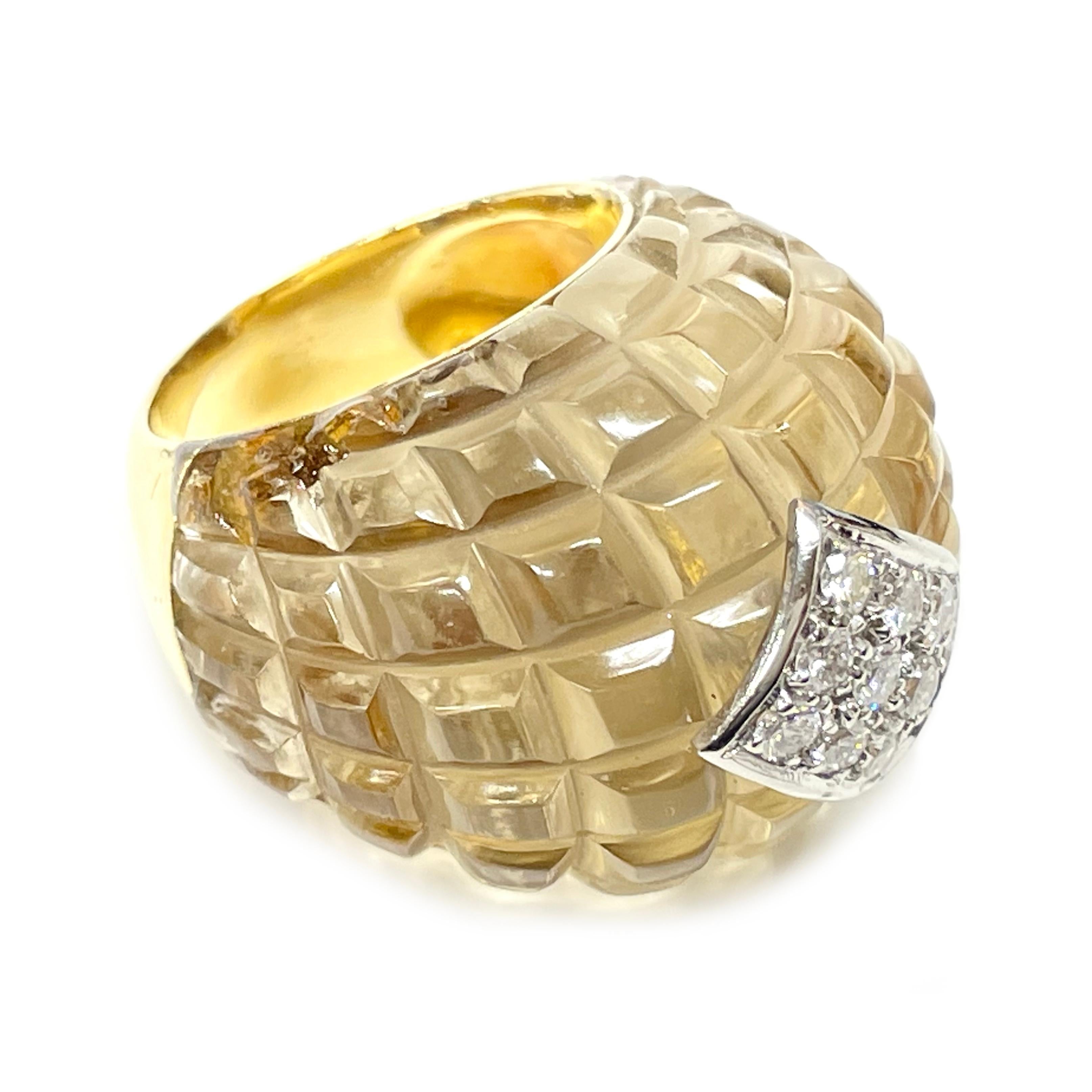 18 Karat Yellow Gold Diamond Quartz Ring. The front half of the ring features a clear faceted quartz design with a cluster of nine round diamonds pave set in white gold at the center. The diamonds measure 2.0mm for a total carat weight of 0.27tcw.